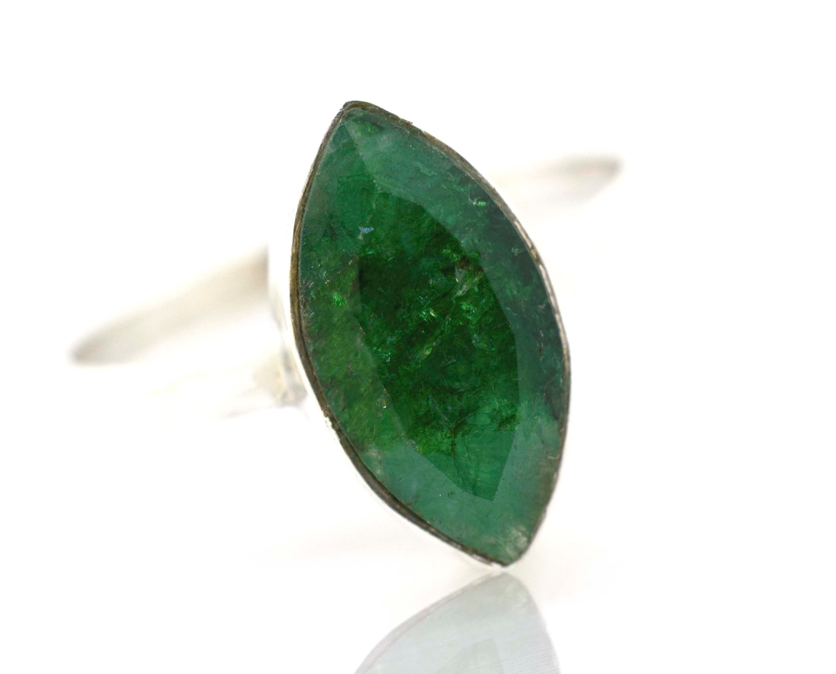 A Simple Marquise Shaped Gemstone Ring on a white surface.