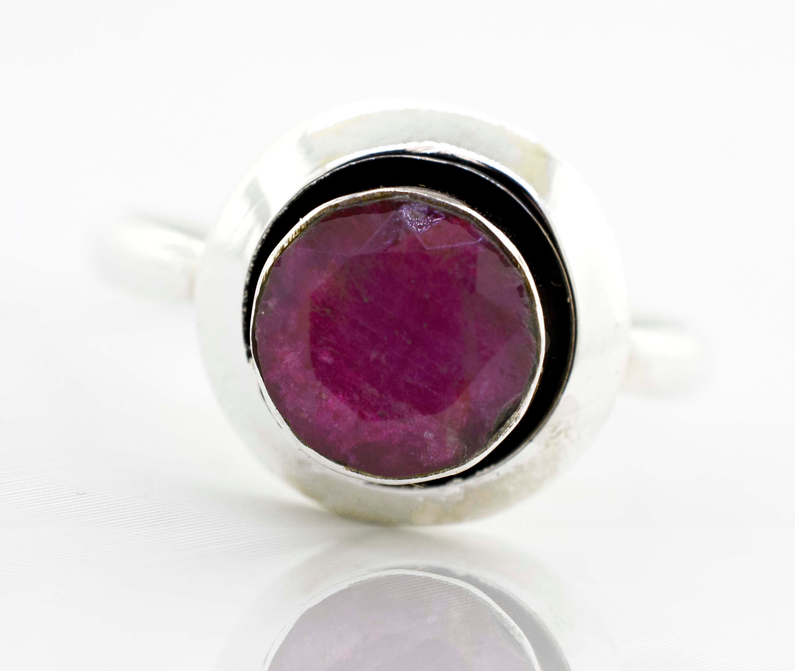 A boho-inspired Round Gemstone Ring With Oxidized Outline featuring a dazzling ruby stone.