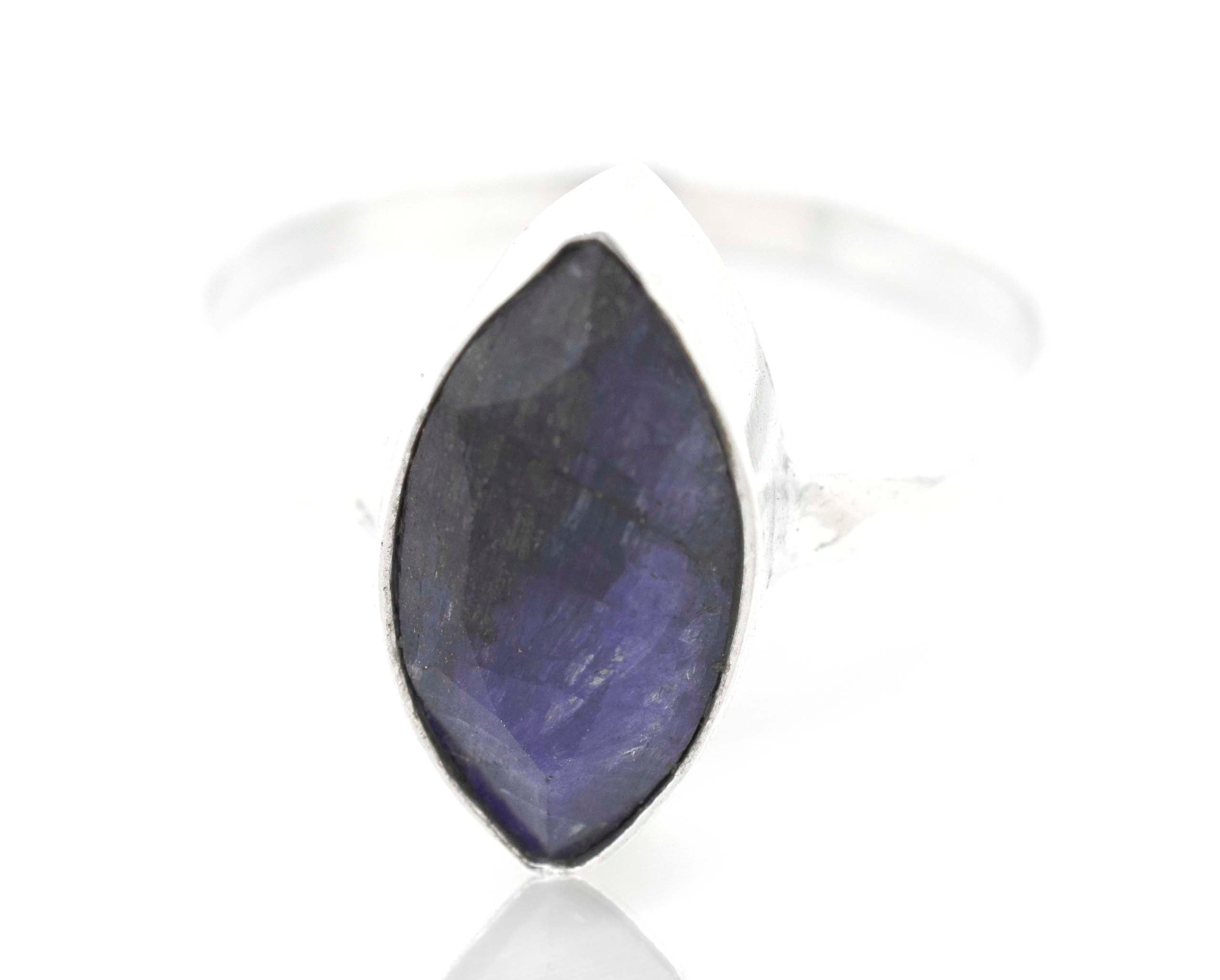 An indie Simple Marquise Shaped Gemstone Ring with a blue sapphire stone.