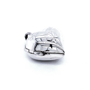 A Small Heart Shaped Locket with Star Etching adorned with engraved floral patterns, featuring a radiant rhodium finish.