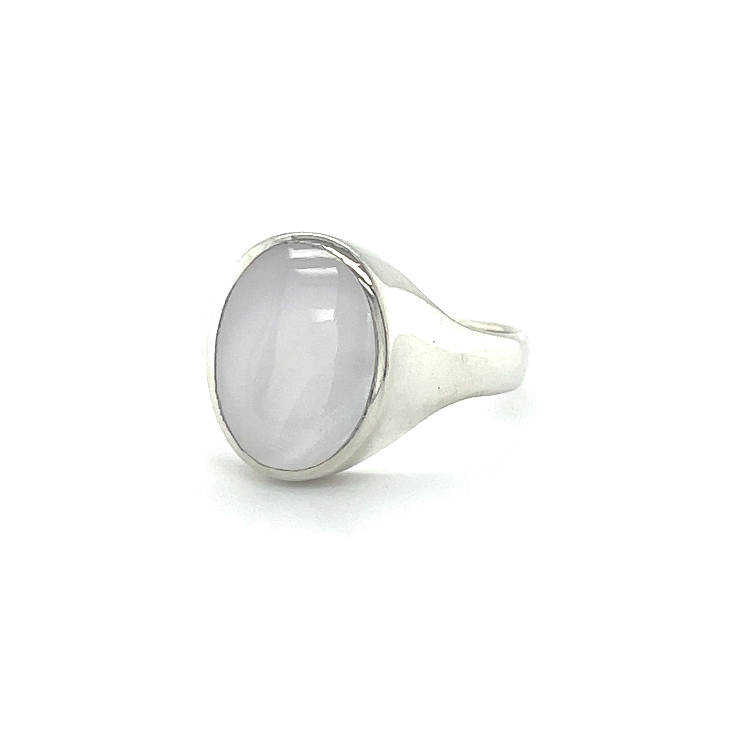A Sleek Oval Inlaid Stone Signet Ring on a white background.
