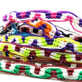 A pile of Super Silver Colorful Friendship Bracelets in bright and colorful designs, perfect for everyday style, placed on a white background.
