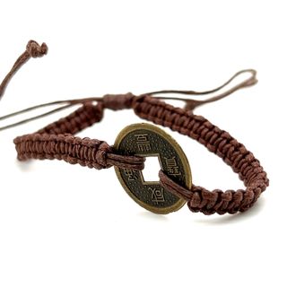 An adjustable Knotted Coin Bracelet with a woven coin by Super Silver.