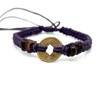 An adjustable Knotted Coin Bracelet from Super Silver featuring a woven coin for a rustic charm.