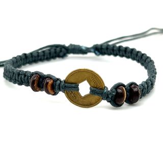 An adjustable Knotted Coin Bracelet with a rustic charm and a woven coin made by Super Silver.