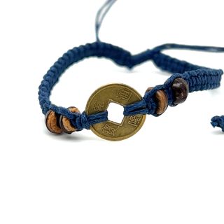 An adjustable blue Knotted Coin Bracelet by Super Silver, adding a rustic charm.