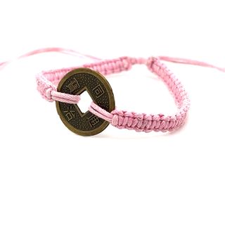An adjustable Super Silver Knotted Coin Bracelet with a touch of rustic charm, featuring a pink hue.