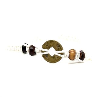 An adjustable Super Silver knotted coin bracelet with rustic charm and beads.