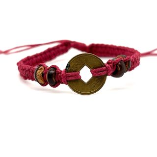 An adjustable Super Silver Knotted Coin Bracelet with rustic charm in a striking red color.