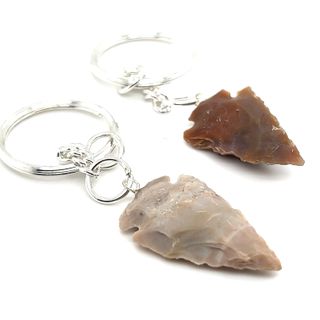 Two Arrowhead Keychains with arrowheads made of stone.