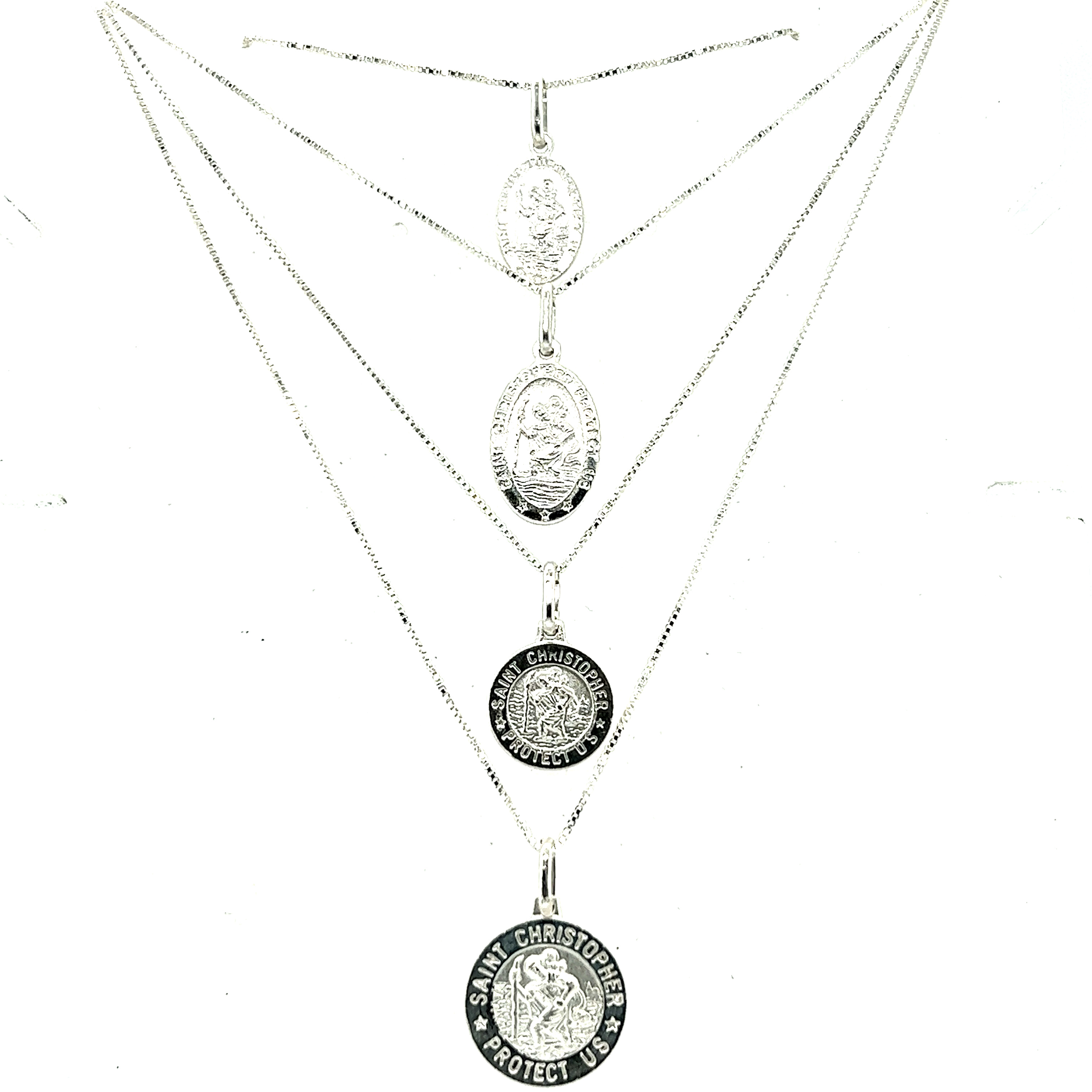 A silver necklace with three Super Silver Saint Christopher Medallions In Various Sizes, the patron saint of travelers, on it.