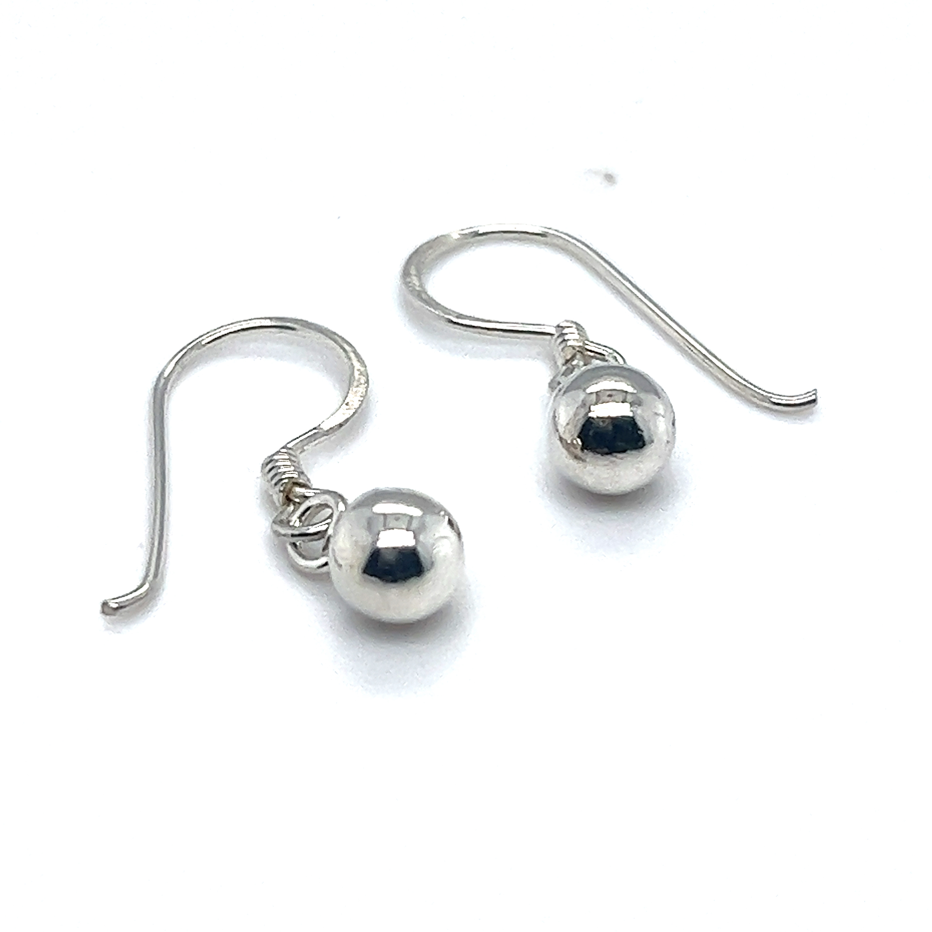 A pair of Simple Dangling Ball Earrings from Super Silver on a white background exuding understated glamour.