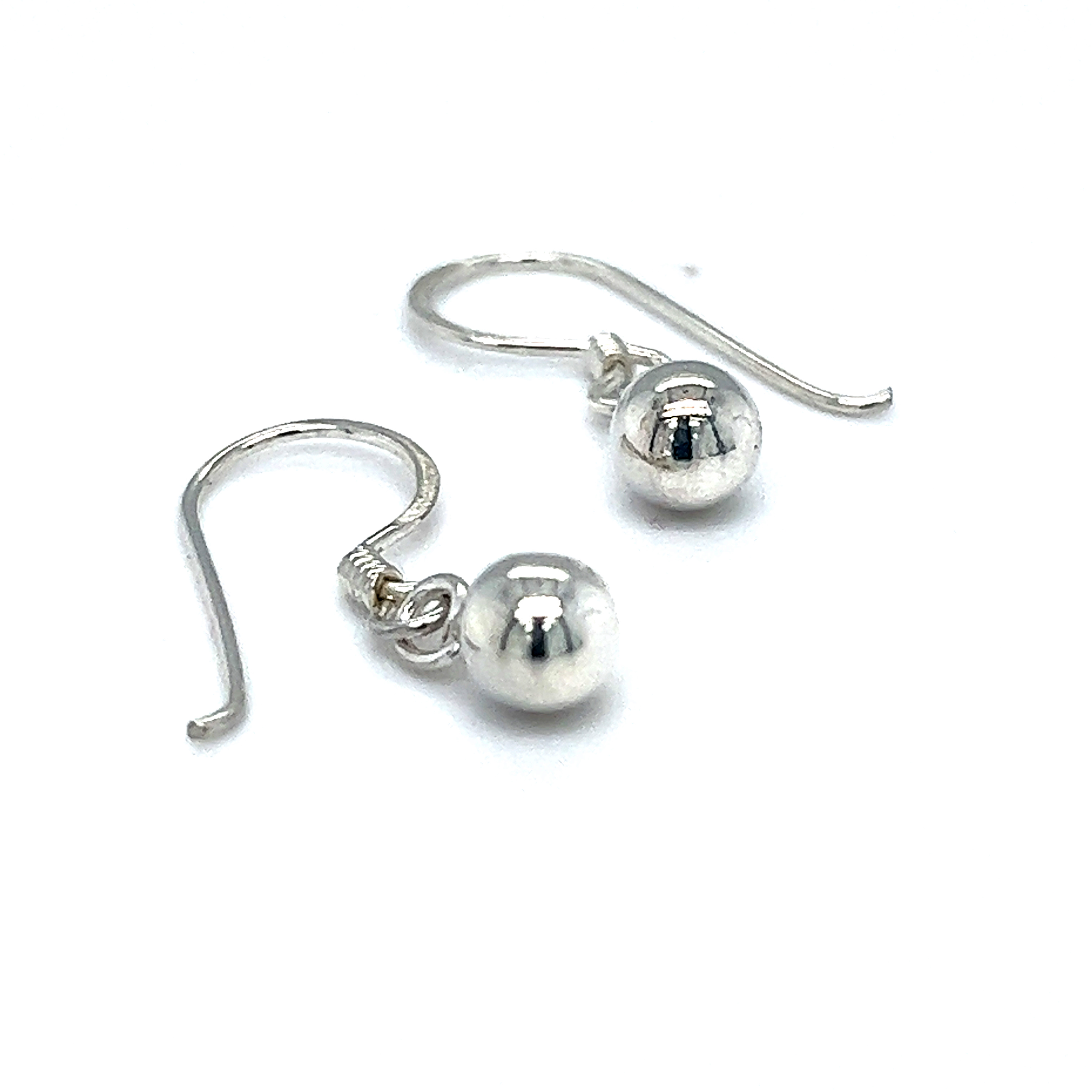 A pair of Simple Dangling Ball Earrings by Super Silver, exuding understated glamour in a chic style, on a white background.