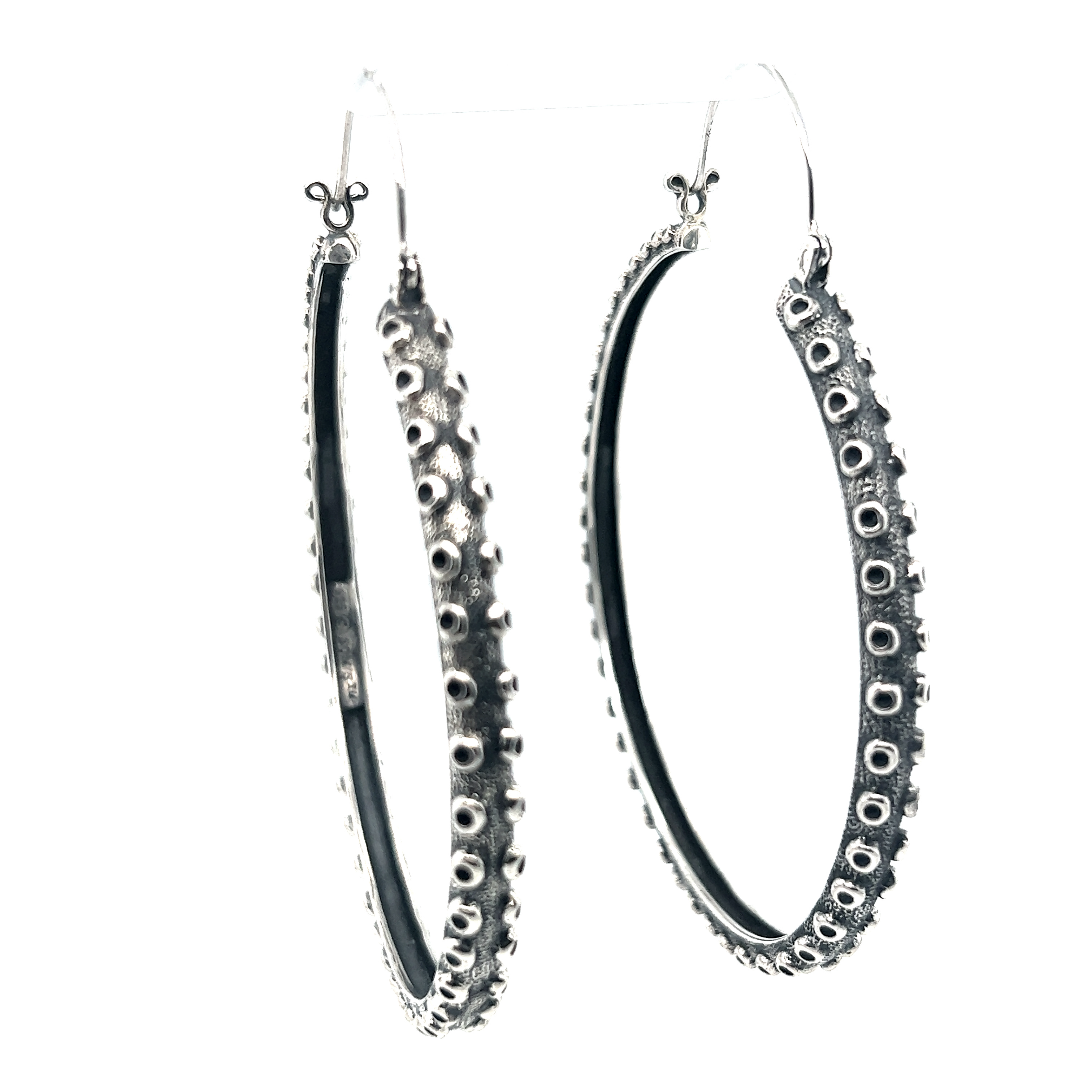 A pair of mesmerizing oversized hoop earrings, known as Colossal Tentacle Hoops by Super Silver, showcased against a white background.