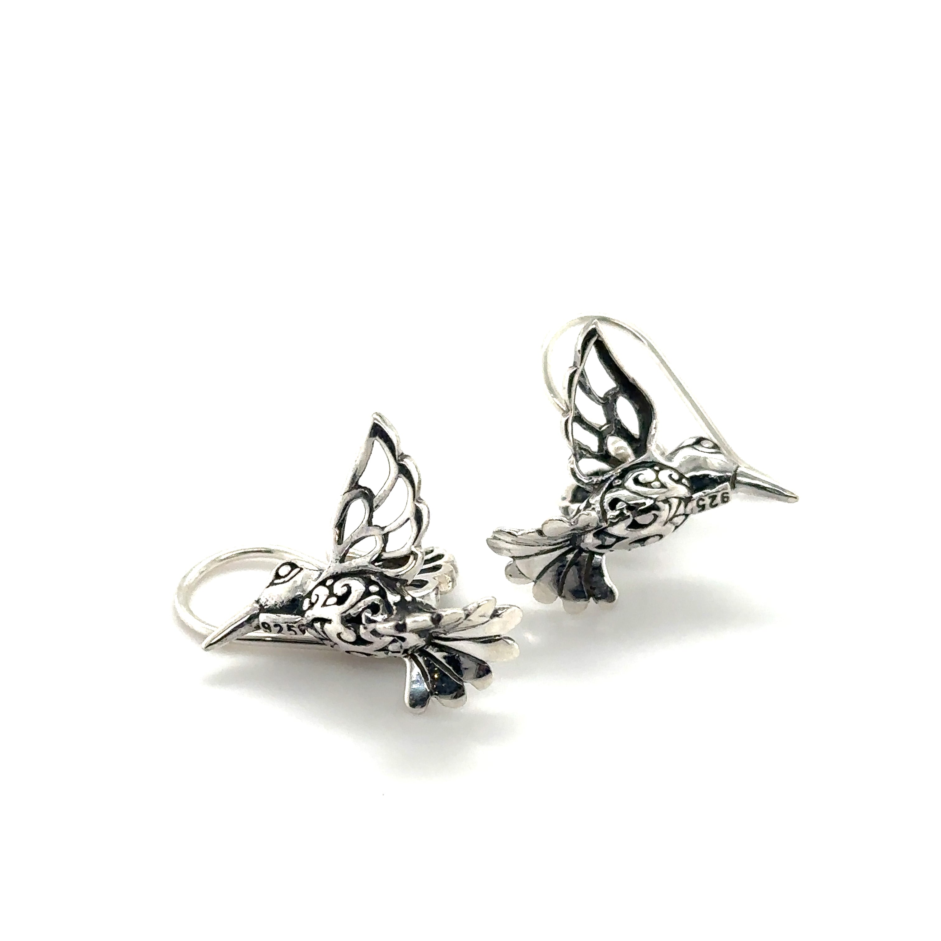 A pair of Super Silver Filigree Hummingbird Earrings elegantly crafted with filigree details, showcased on a pristine white background.