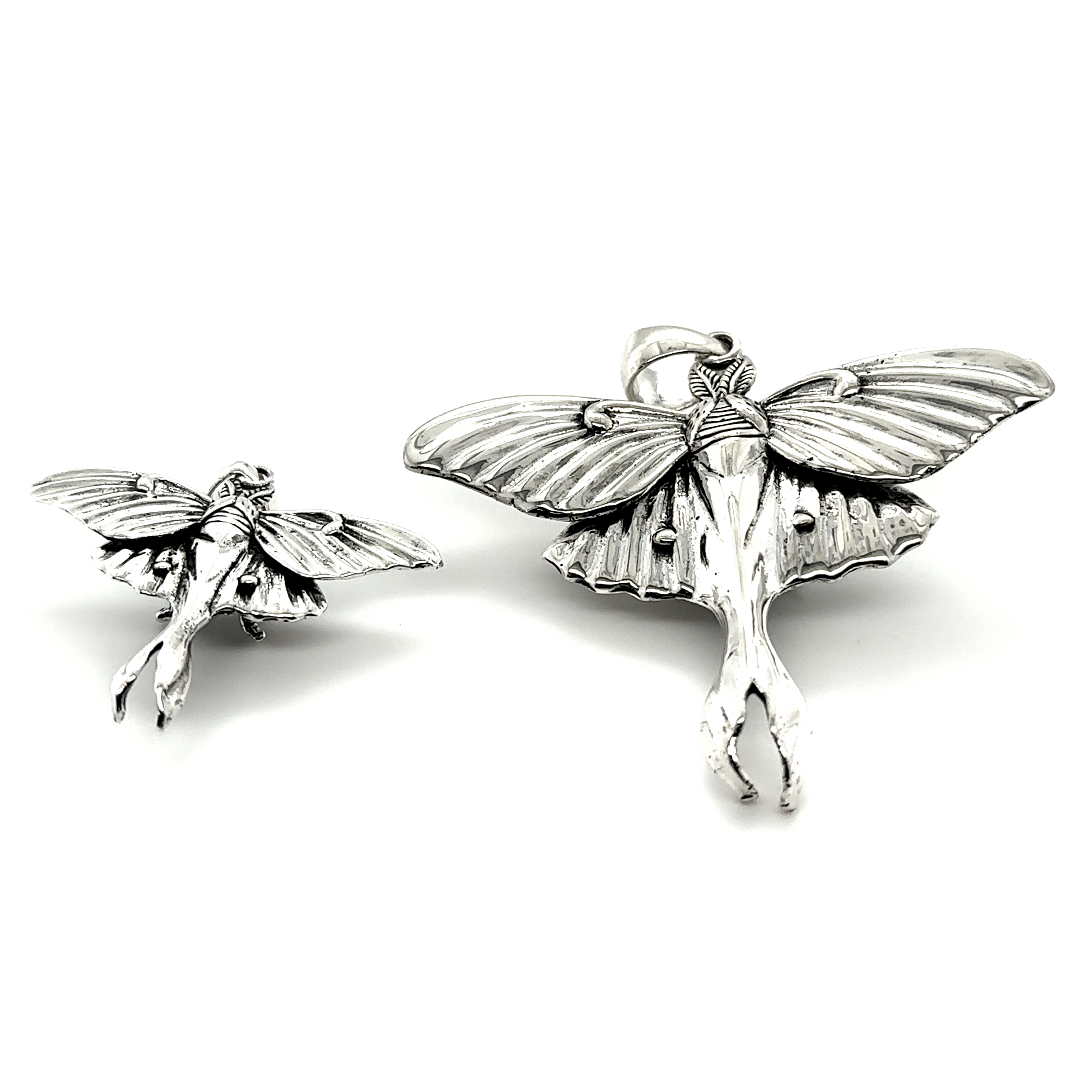 Two Statement Lunar Moth Pendants by Super Silver with wings that symbolize transformation.