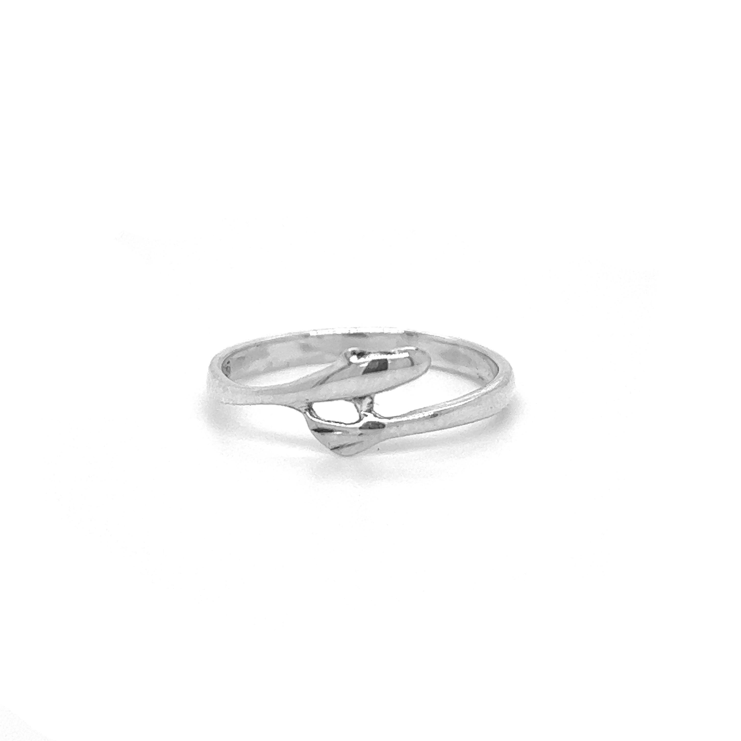 A sterling silver Tiny Dolphin Ring with a diamond in the middle, inspired by the oceanic wonders of Santa Cruz.
