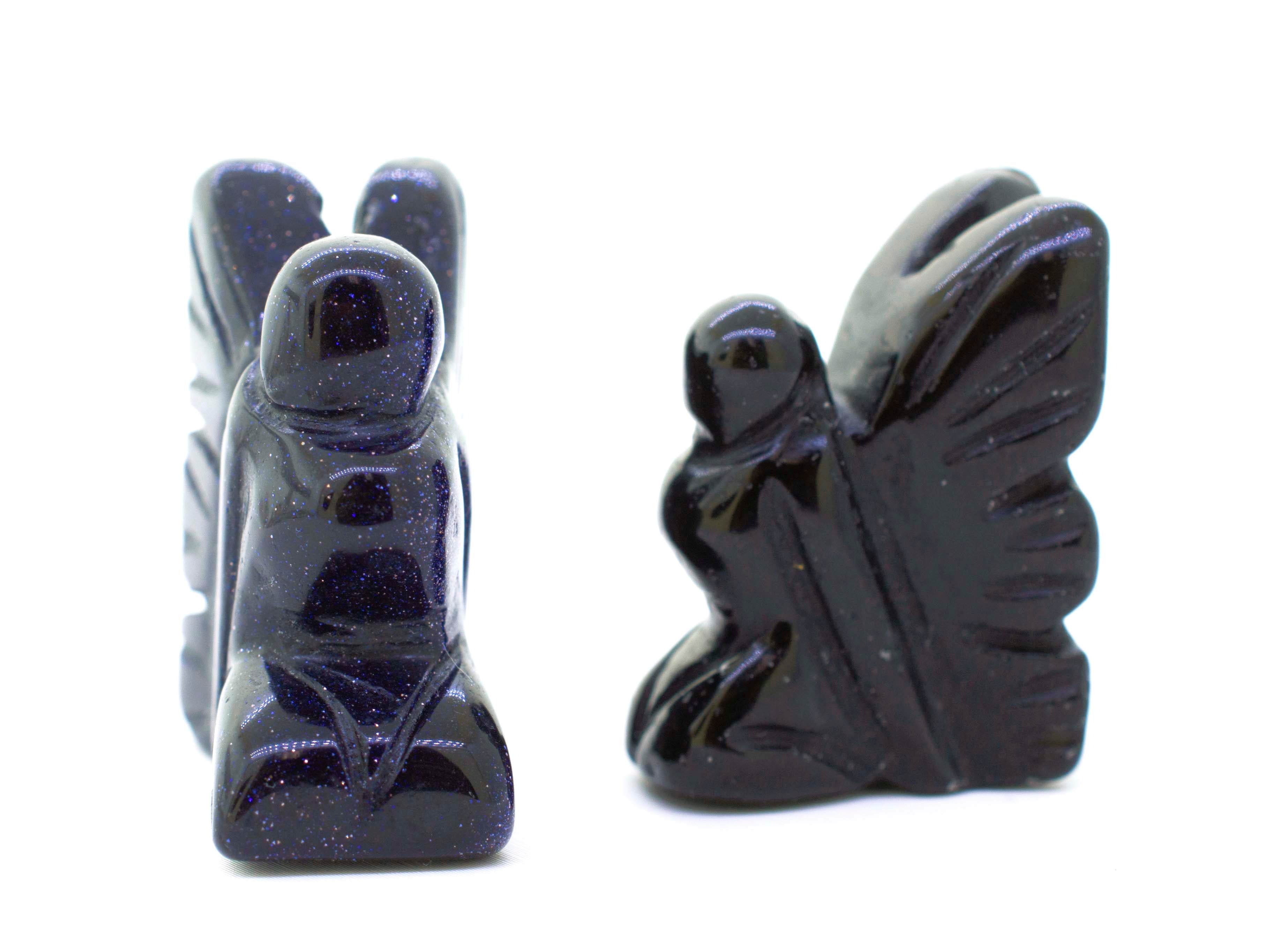 A pair of Carved Fairy Gemstones Figures with wings on them.