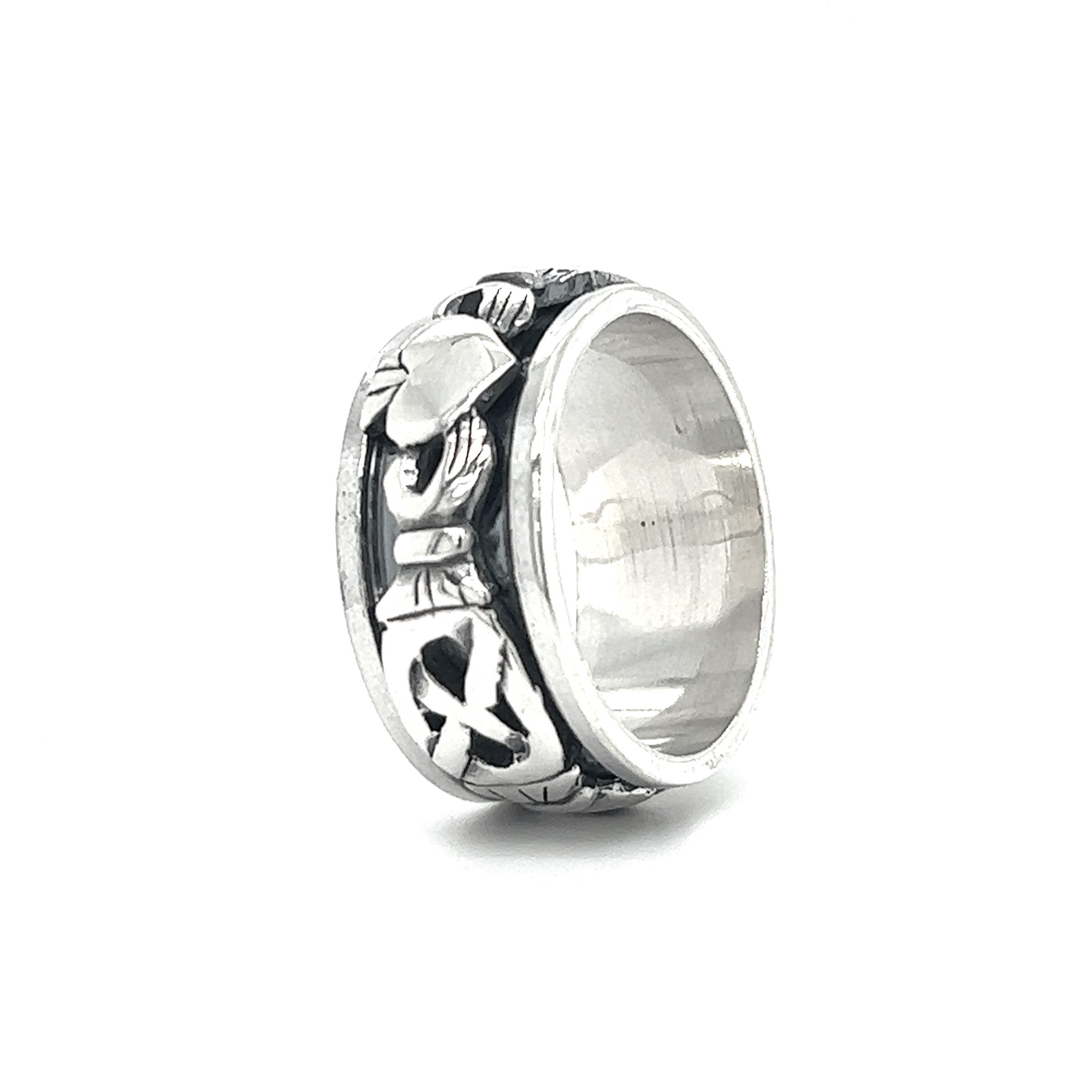 A silver Bold Claddagh Spin Ring with a celtic design on it.