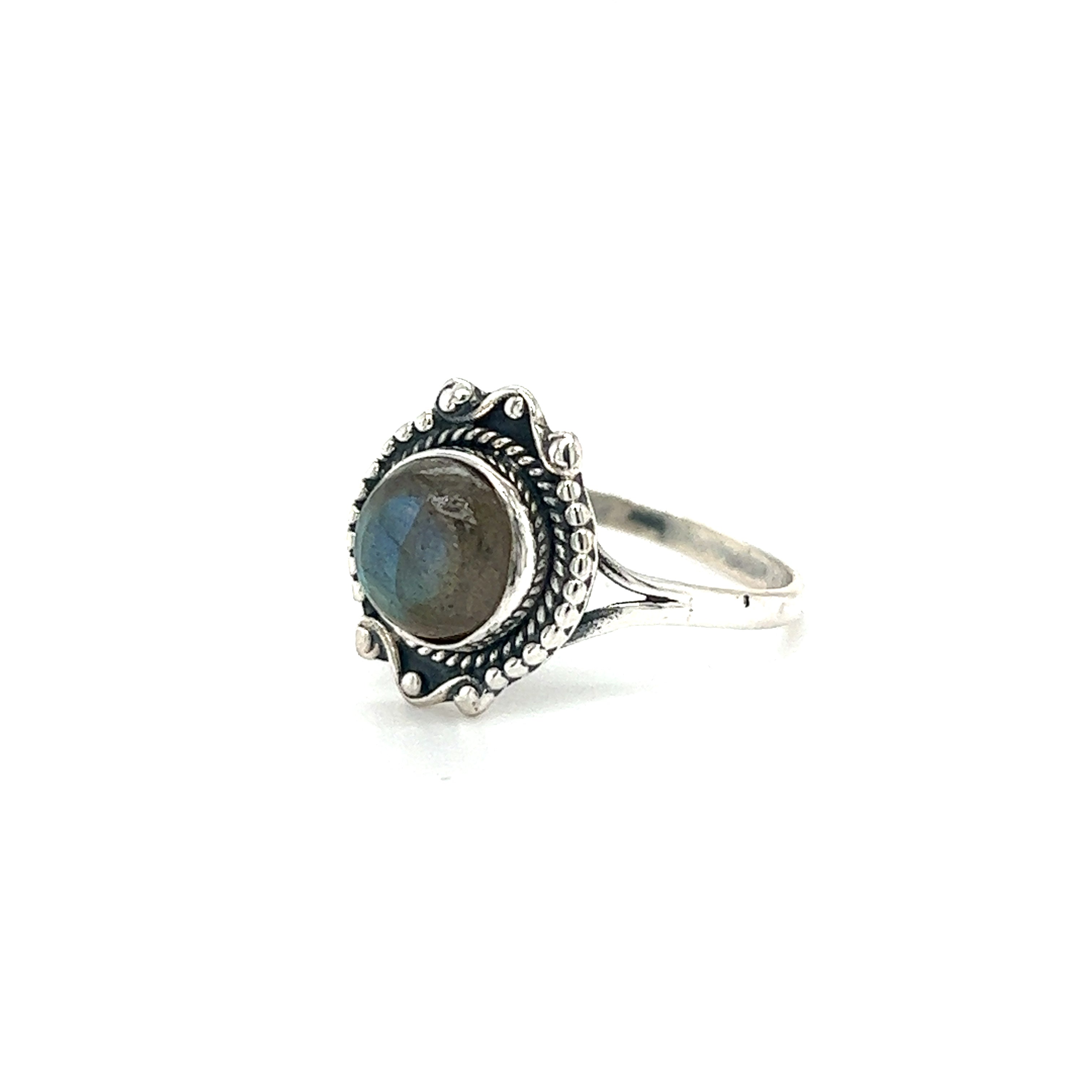 A Round Gemstone Ring With Vintage Setting featuring an ornate band and a round, polished gemstone center exudes bohemian sophistication.