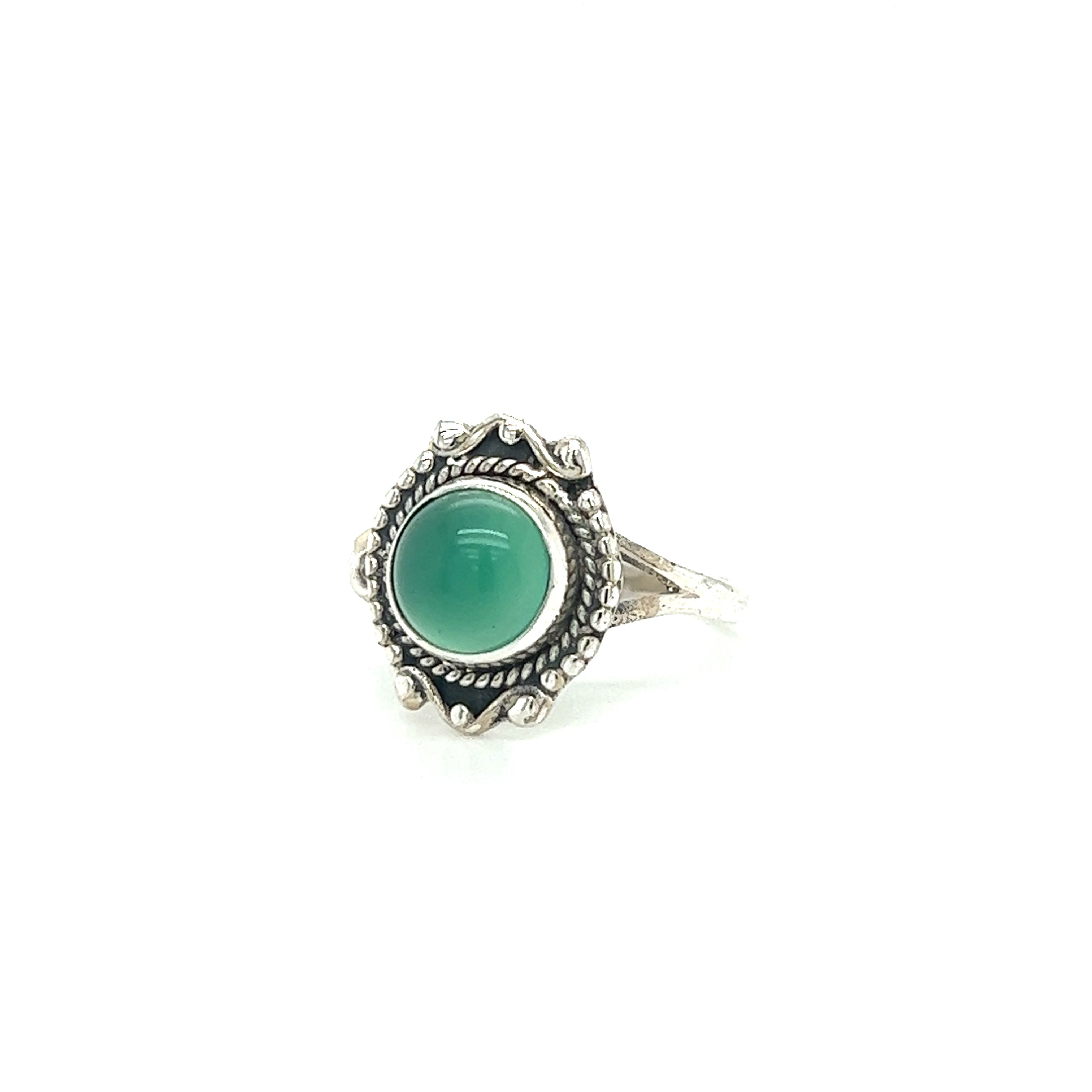 A Round Gemstone Ring With Vintage Setting featuring a green gem set in an ornate bezel with intricate detailing, this sterling silver ring captures the essence of Bohemian jewelry.