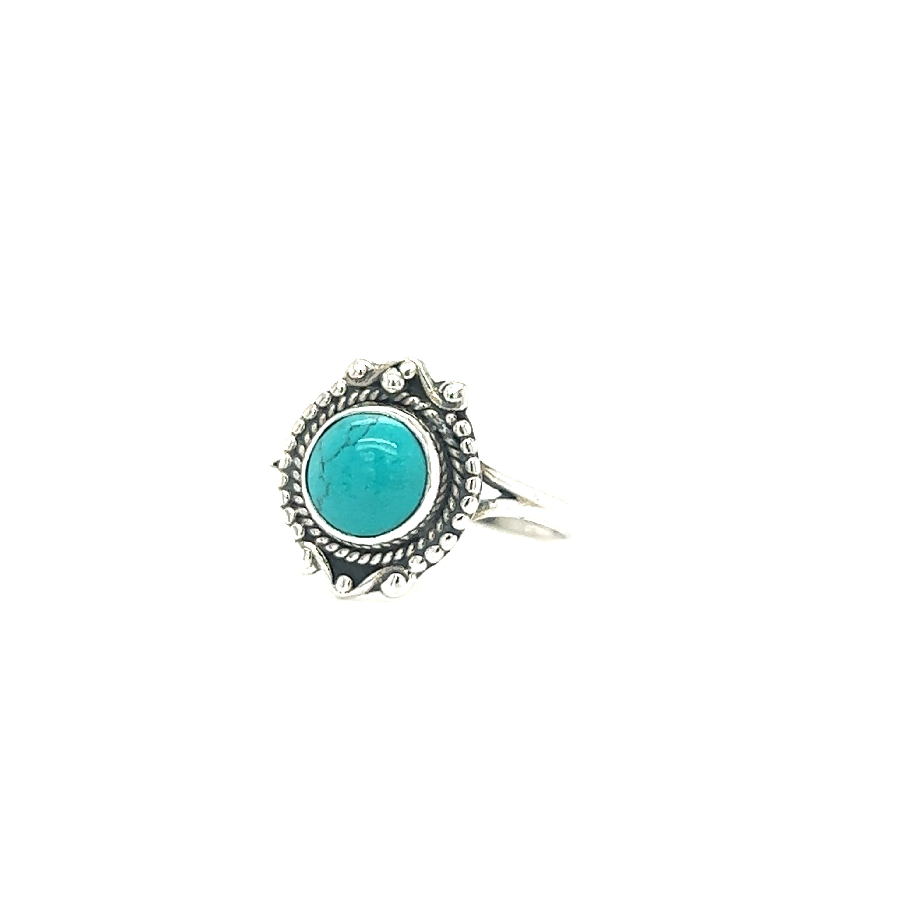 A Round Gemstone Ring With Vintage Setting featuring a round turquoise stone in the center with an ornate, detailed setting, perfect for those who adore Bohemian jewelry.