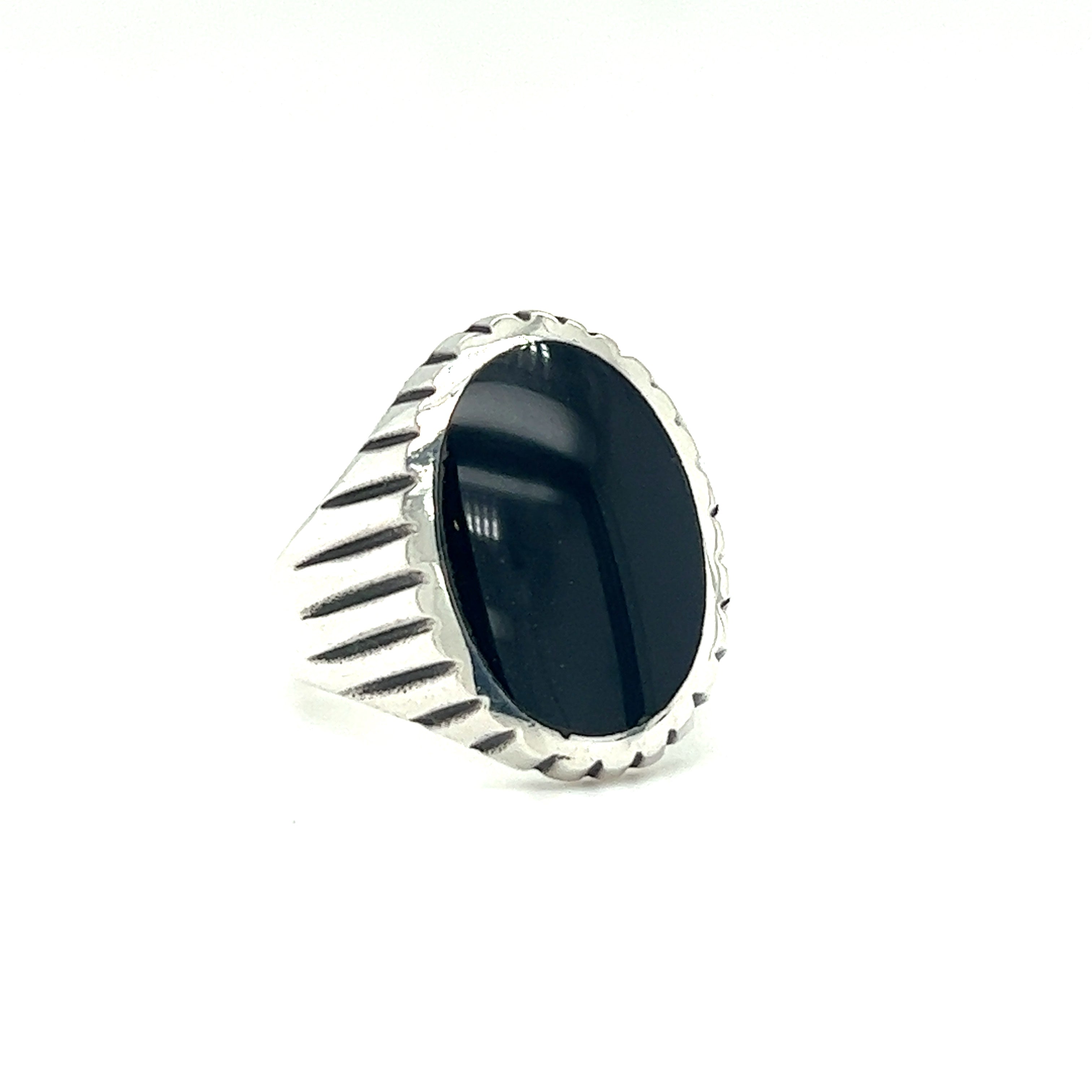 A minimalist silver ring with an oval onyx stone with a fine oxidized scale pattern.