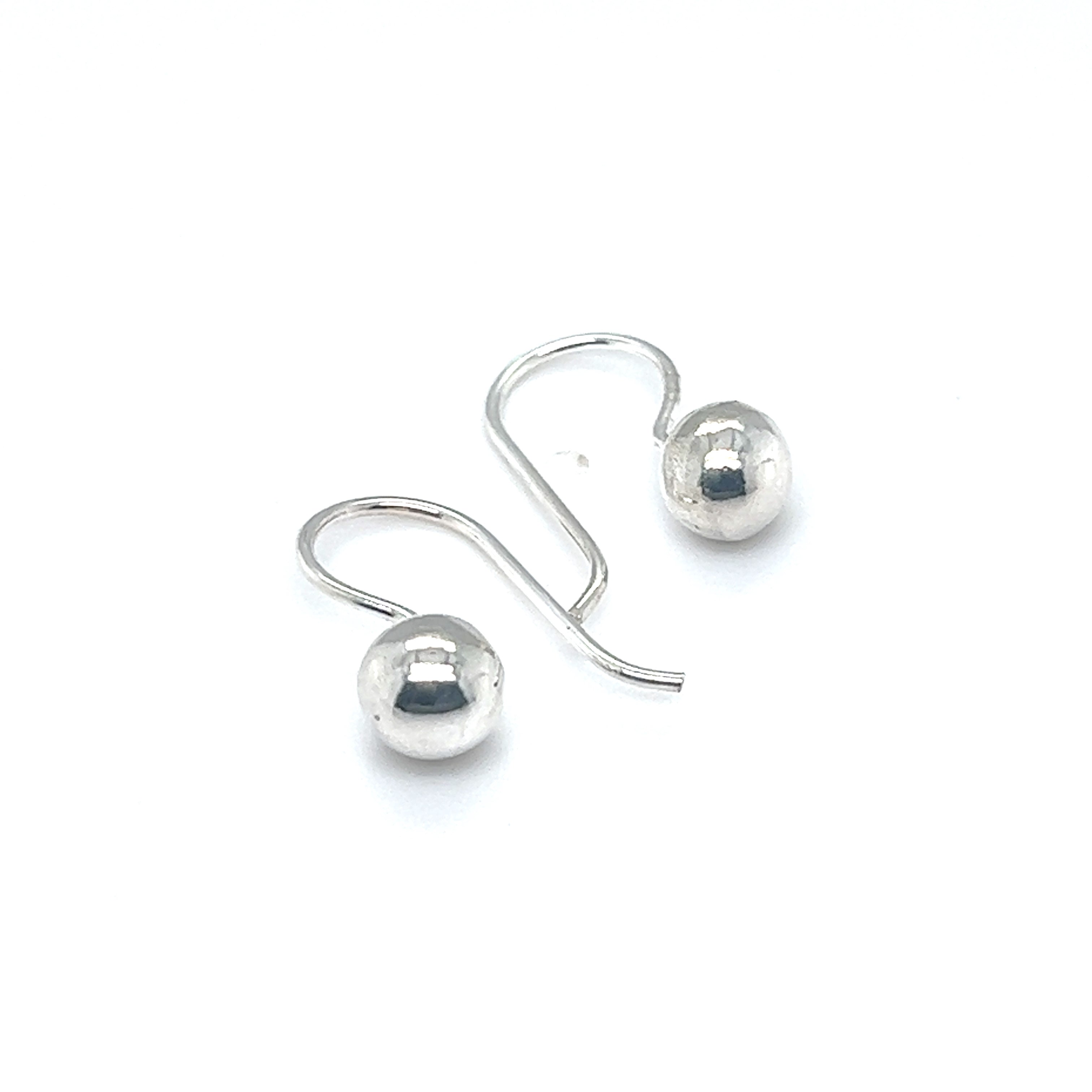 Timeless sophistication embodied in a pair of Super Silver Dainty Fixed Ball Earrings against a serene white background.