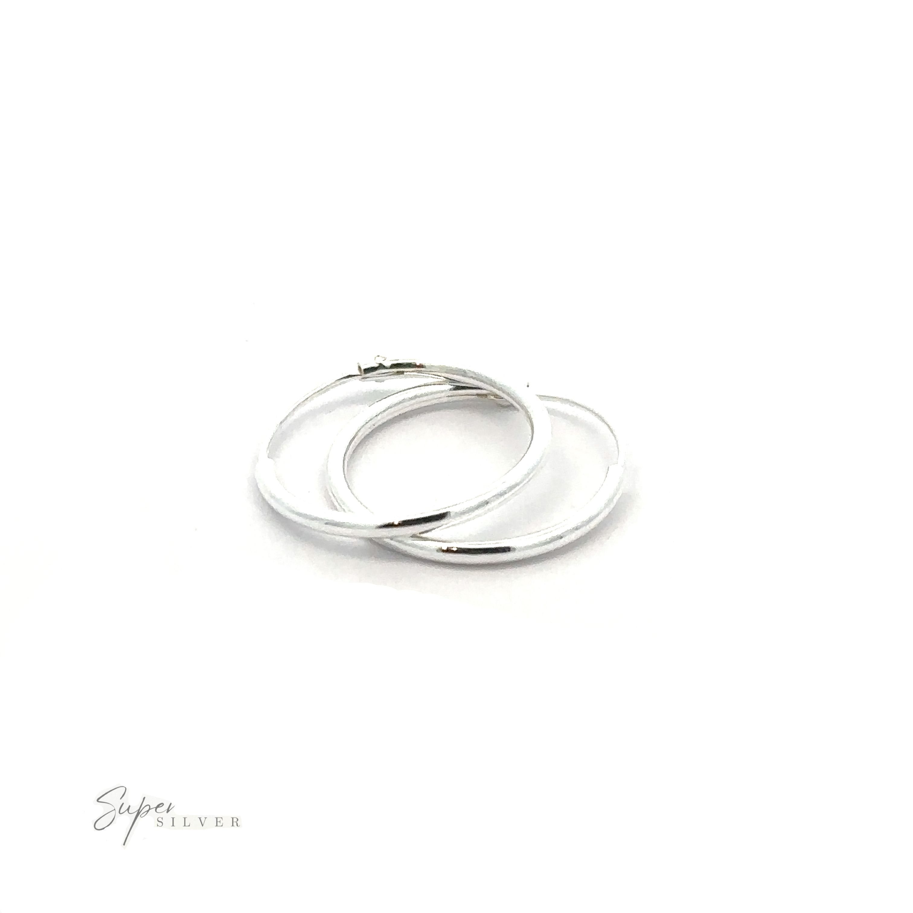 A pair of 1.2mm Infinity Hoops, crafted with an elegant silver infinity design, rests gracefully on a white background. Made from .925 Sterling Silver, they promise timeless beauty and unparalleled quality.