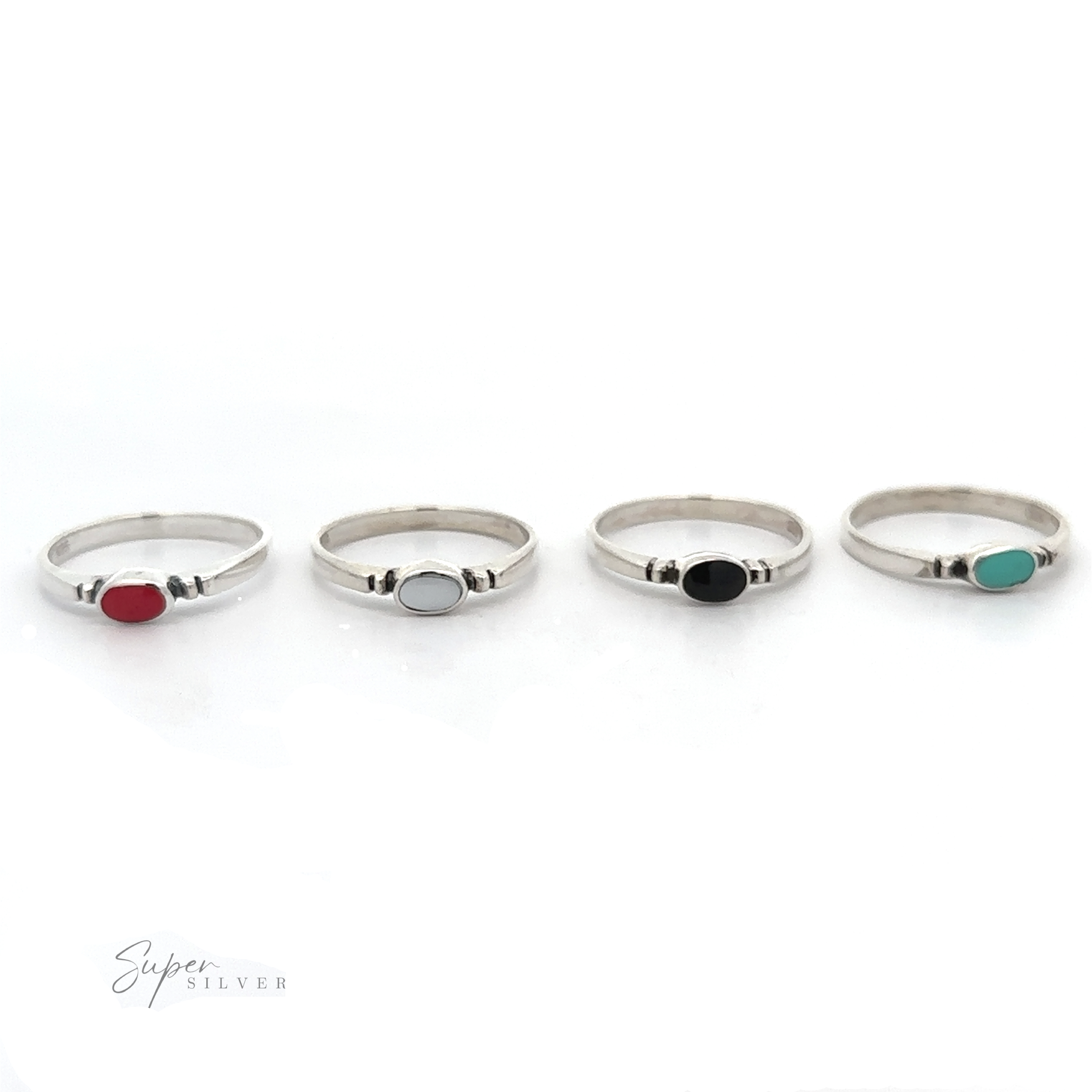 A set of four Small Horizontal Oval Inlay Rings with dainty and sleek designs featuring different colored stones.