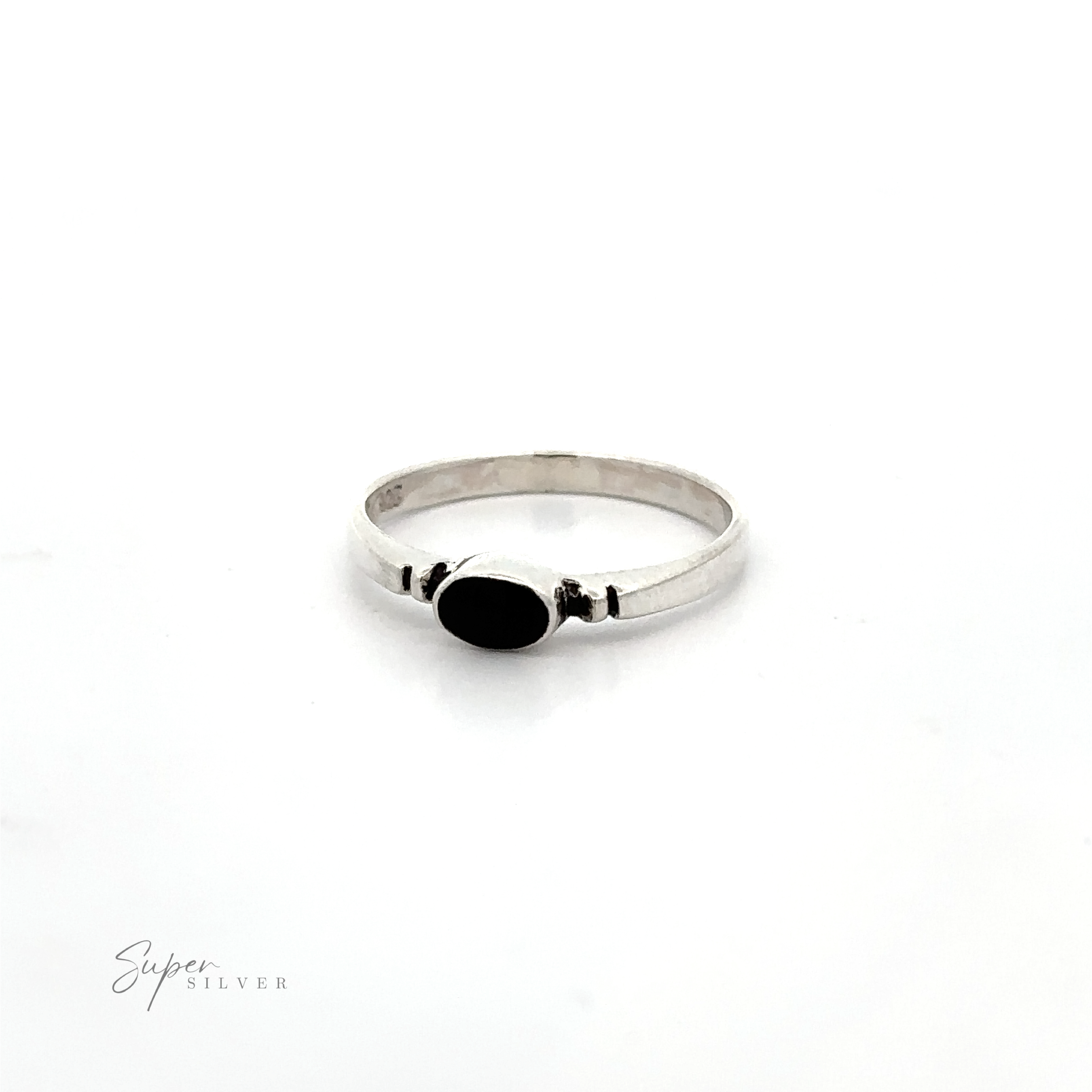 A Small Horizontal Oval Inlay Ring with notched details on a white background.