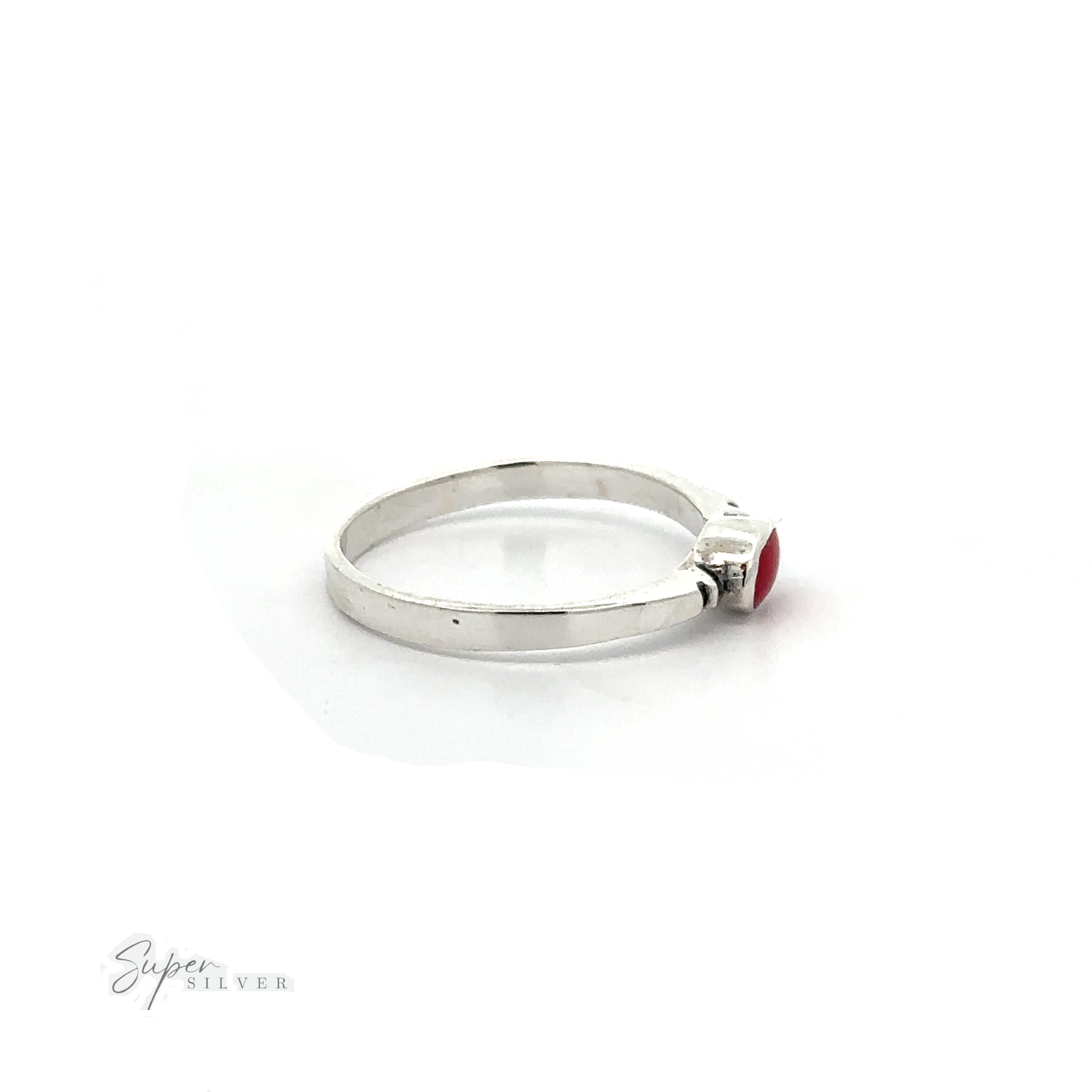 A dainty Small Horizontal Oval Inlay Ring with a sleek design and a red stone.