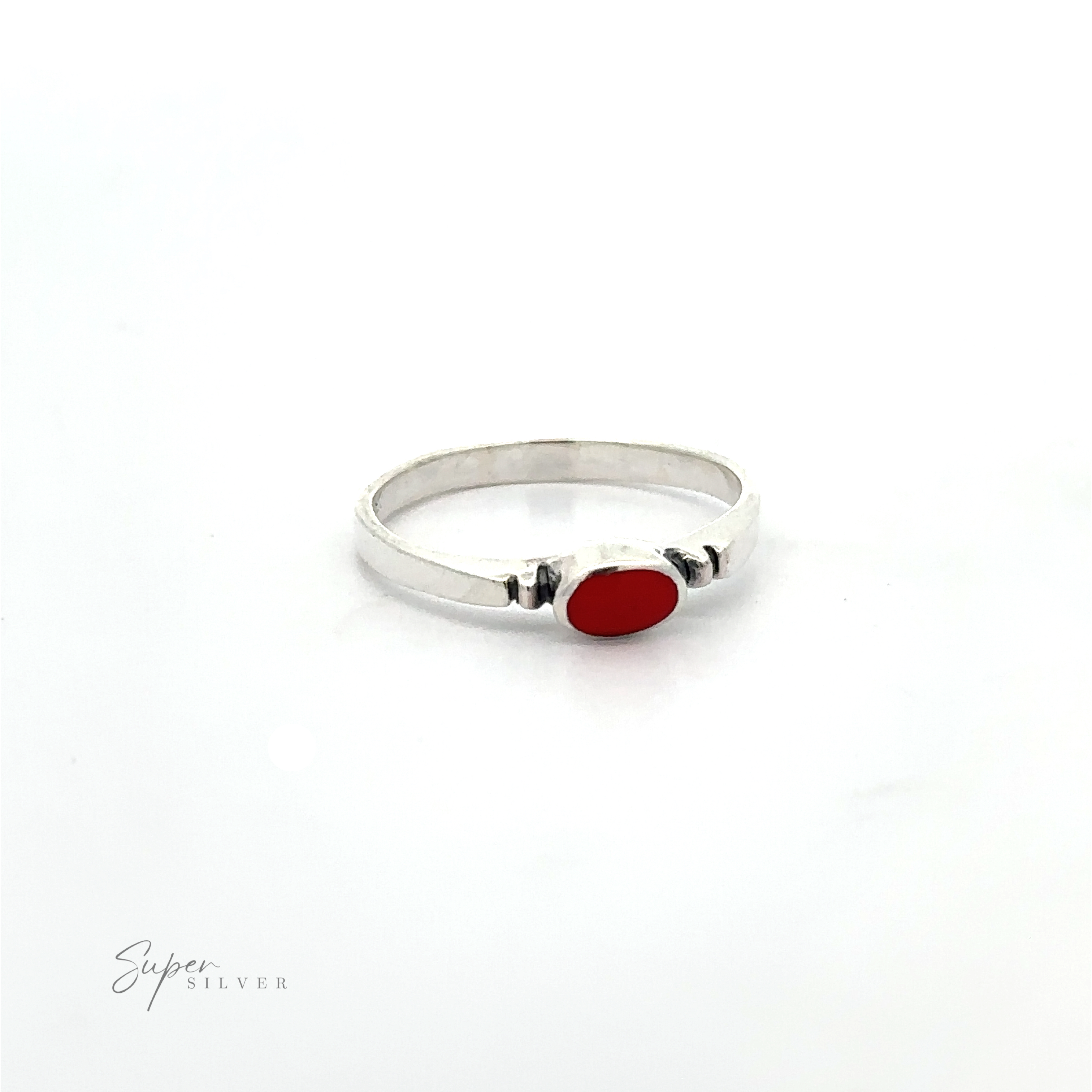 A dainty and sleek Small Horizontal Oval Inlay Ring with a minimalist style and a sideways oval red stone on it.
