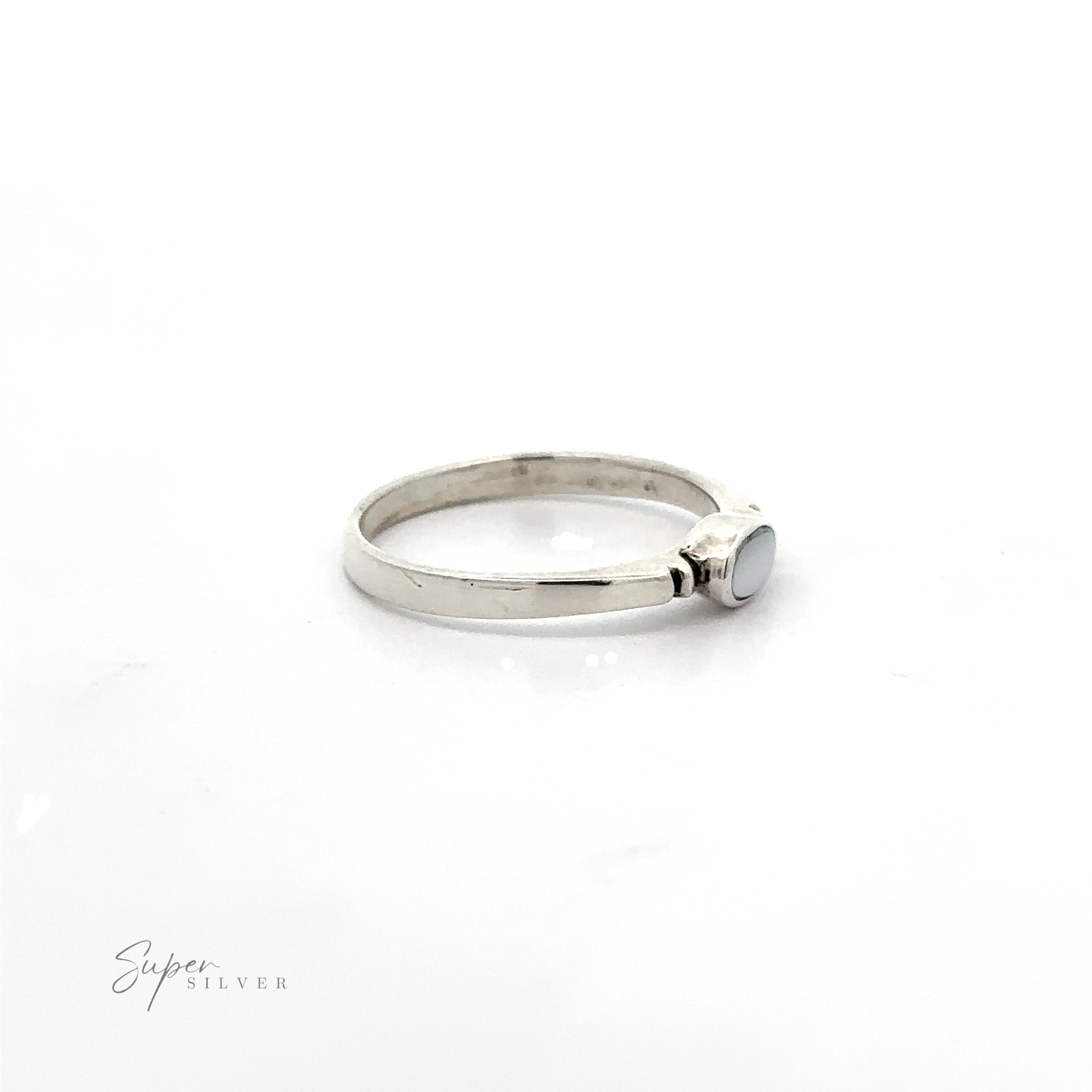 A dainty and sleek Small Horizontal Oval Inlay Ring with a sideways oval blue stone.