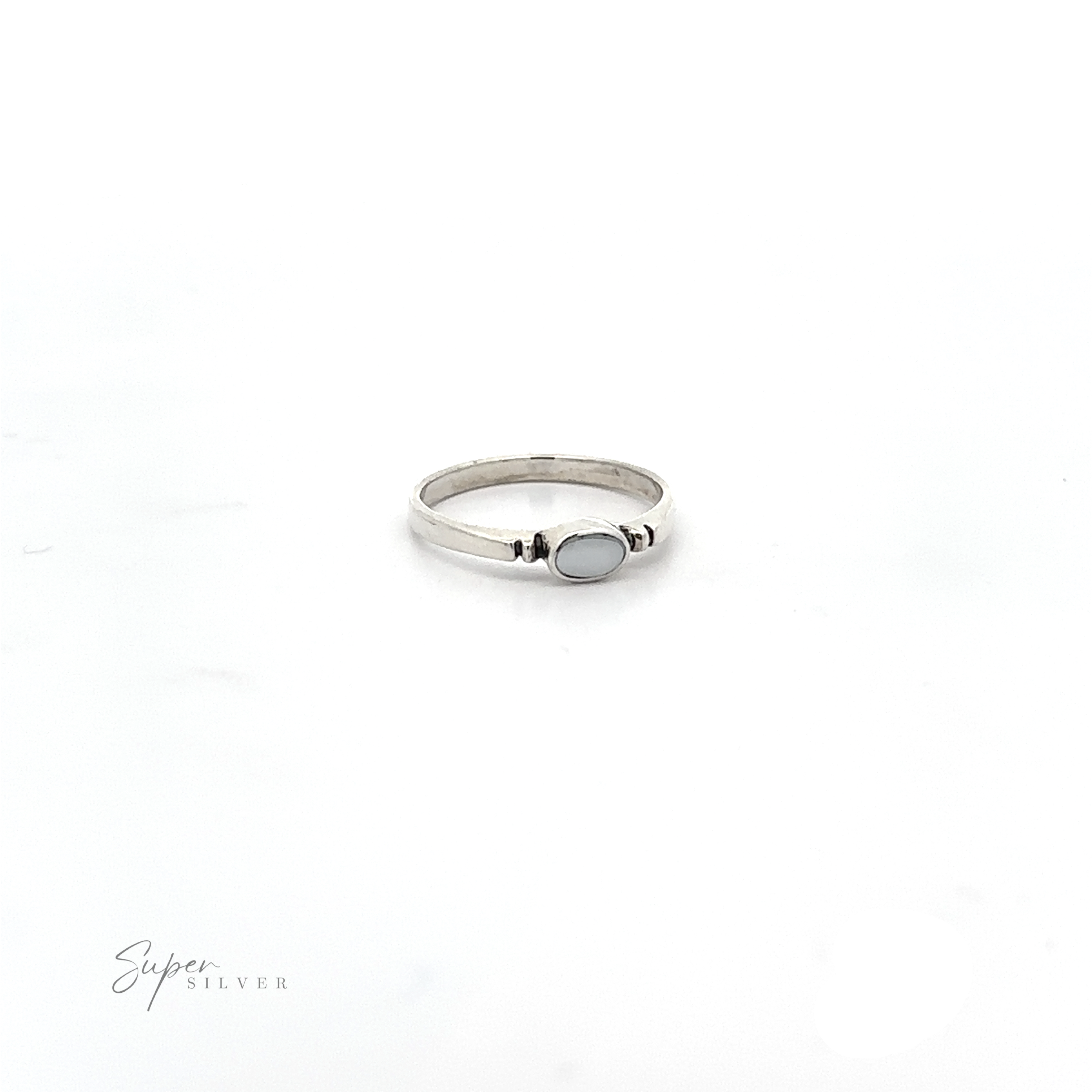 A dainty and sleek Small Horizontal Oval Inlay Ring on a minimalist style background.