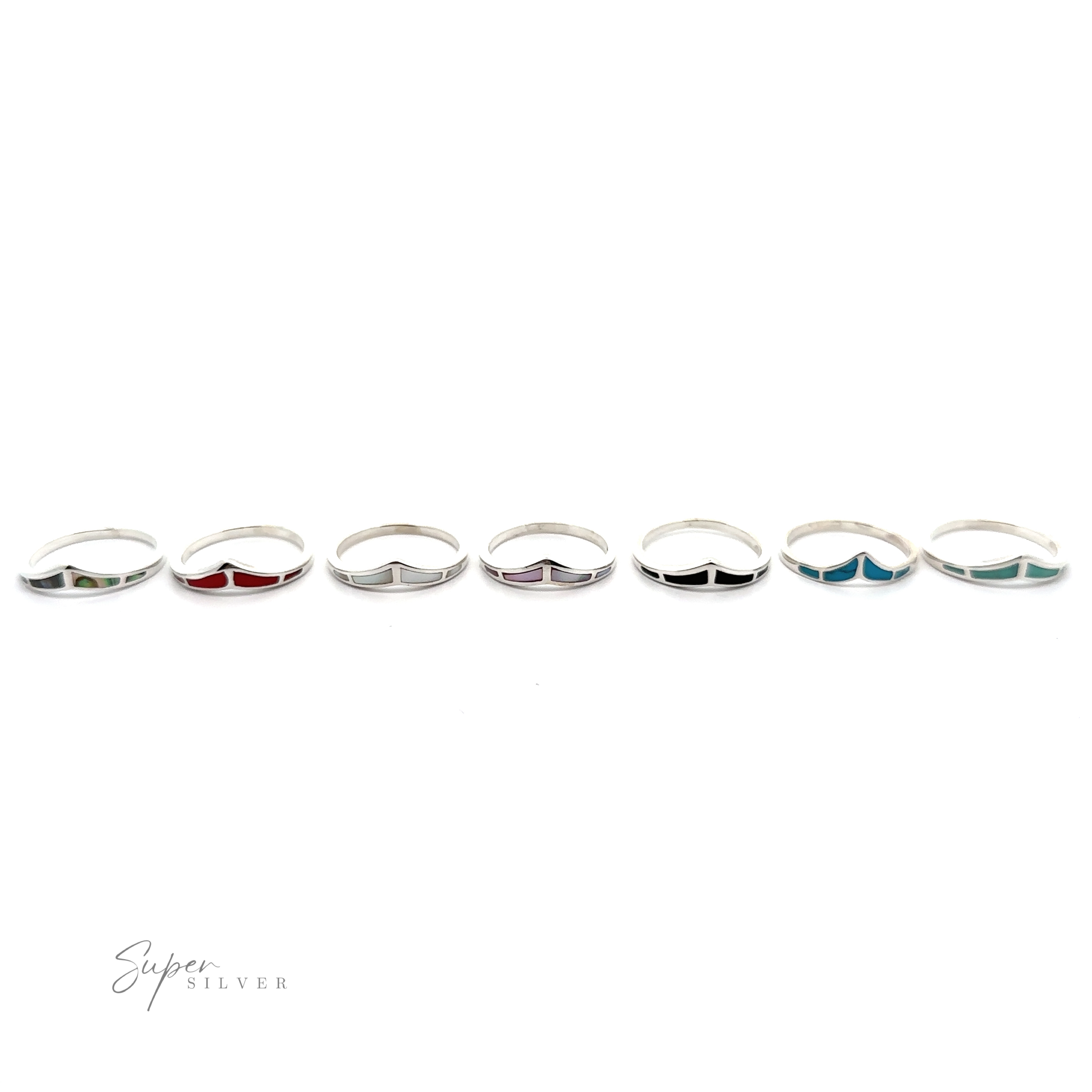 A row of Trendy Chevron Rings With Inlaid Stones on a white background.