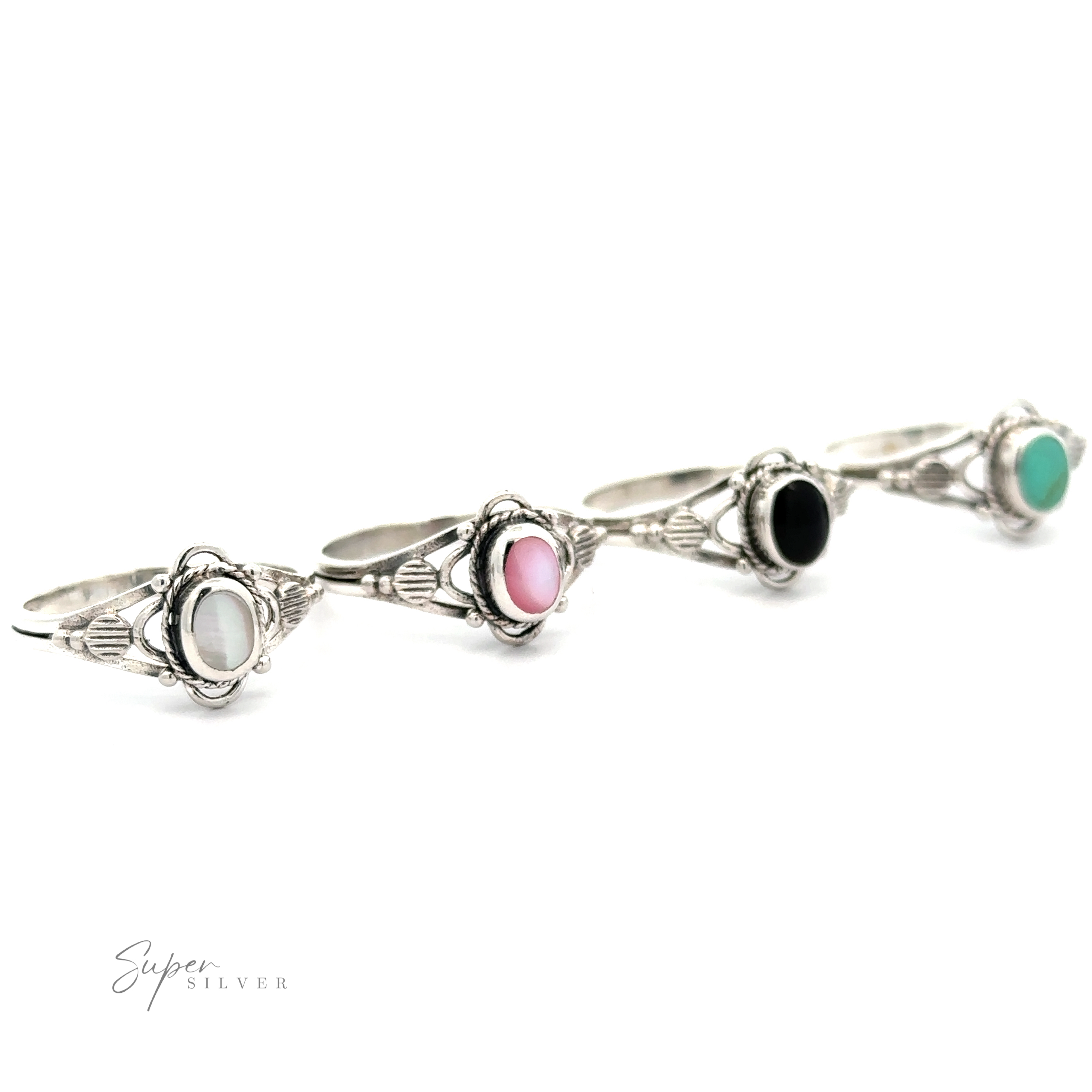 A set of four Fancy Oval Inlay Stone Rings with different colored stones - mother-of-pearl and onyx.