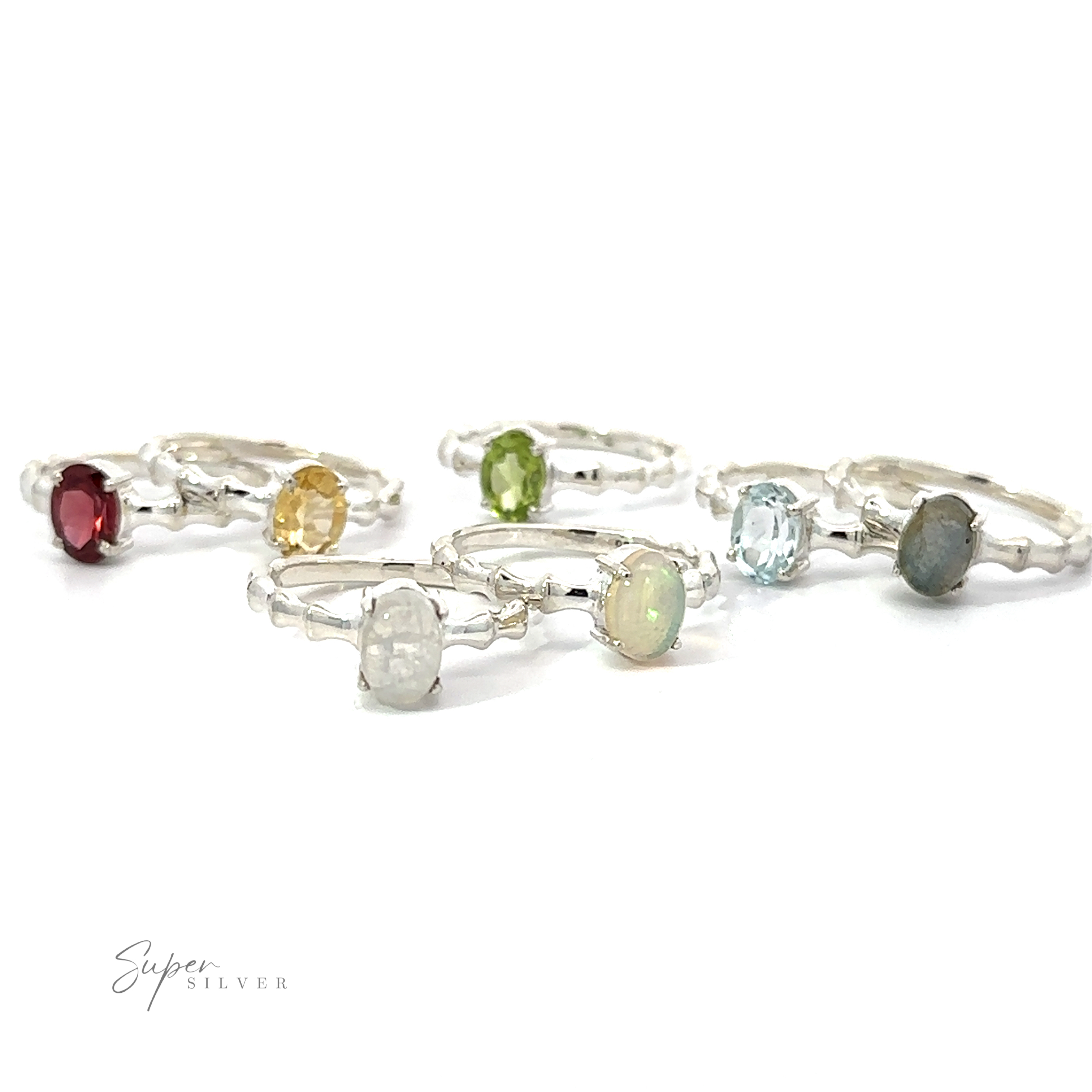 A collection of Pronged Oval Gemstone Rings with Textured Bands, including Blue Topaz, on a white background.