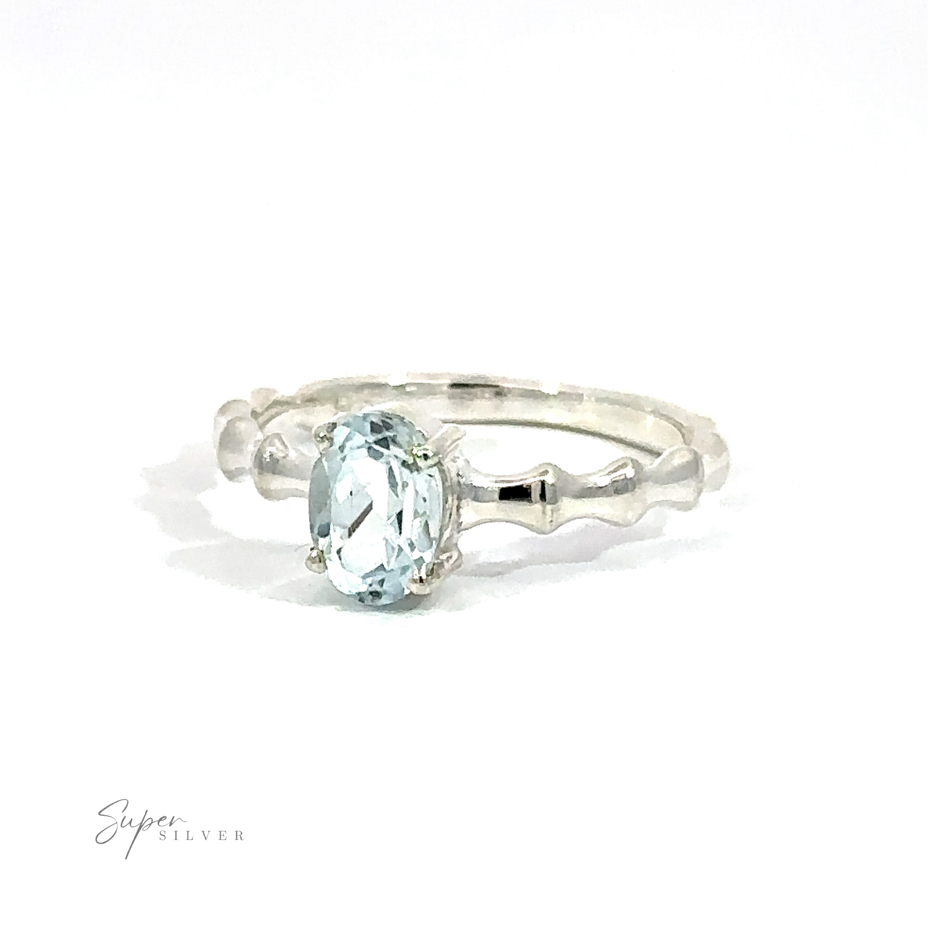 Pronged Oval Aquamarine Ring with Textured Band on a white background.