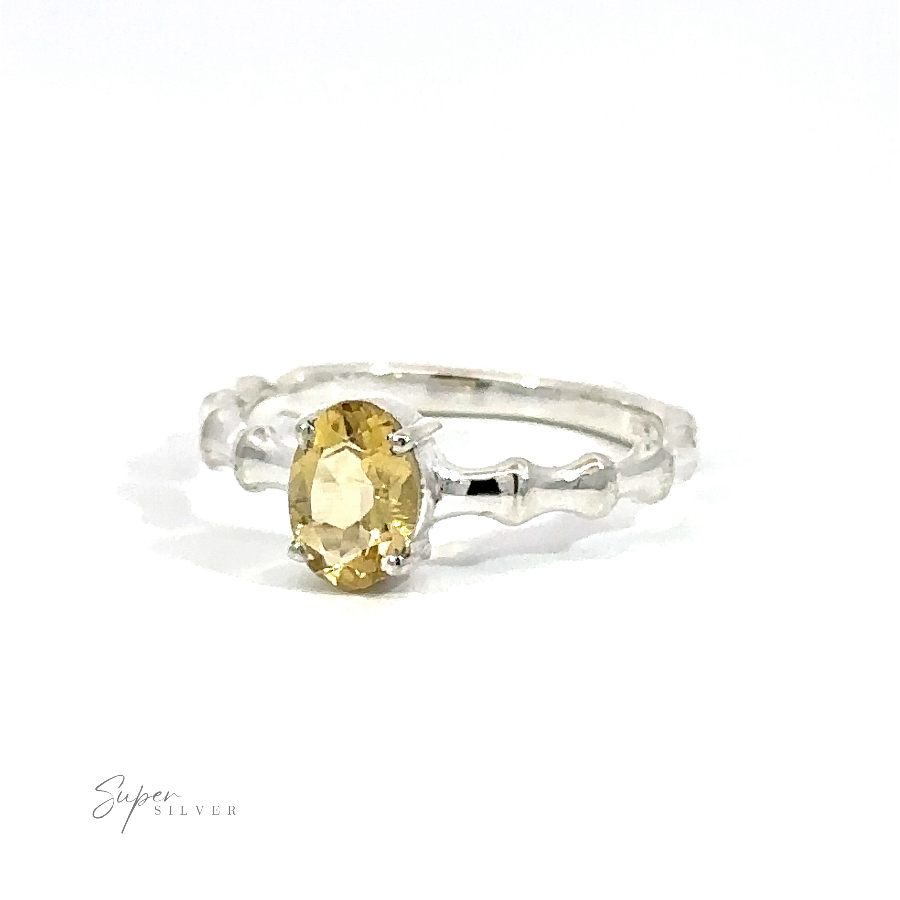 Pronged Oval Gemstone Ring with Textured Band with an oval-cut blue topaz on a white background.