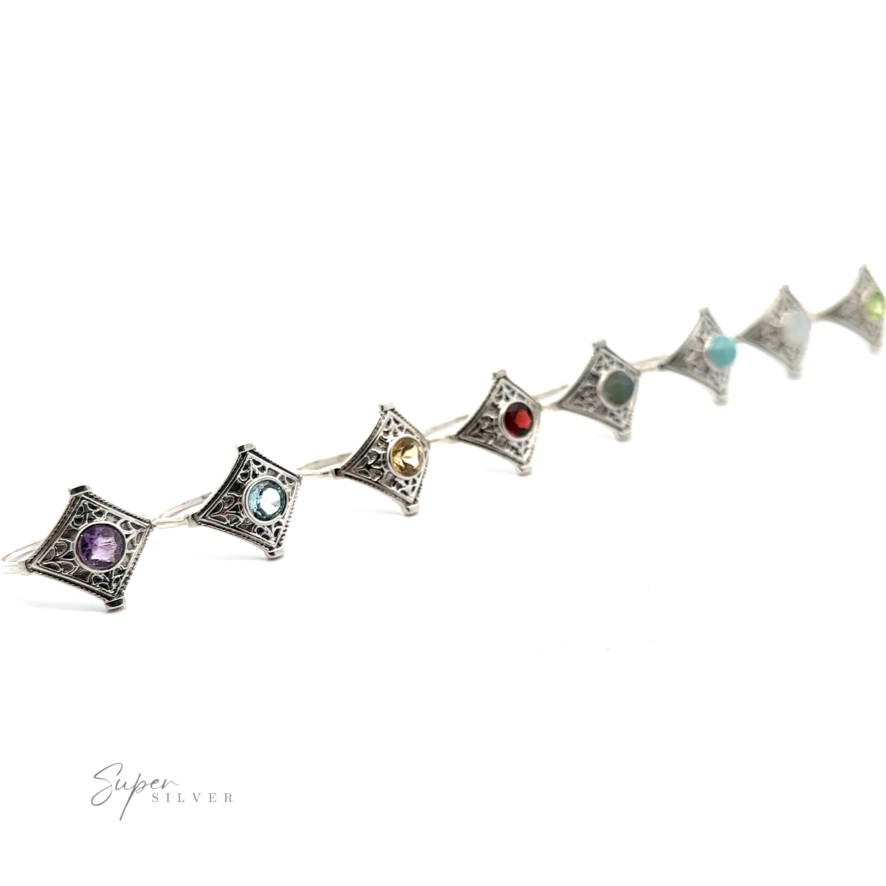 A line of six Intricate Diamond Silver Rings with a Round Gemstone, against a white background.