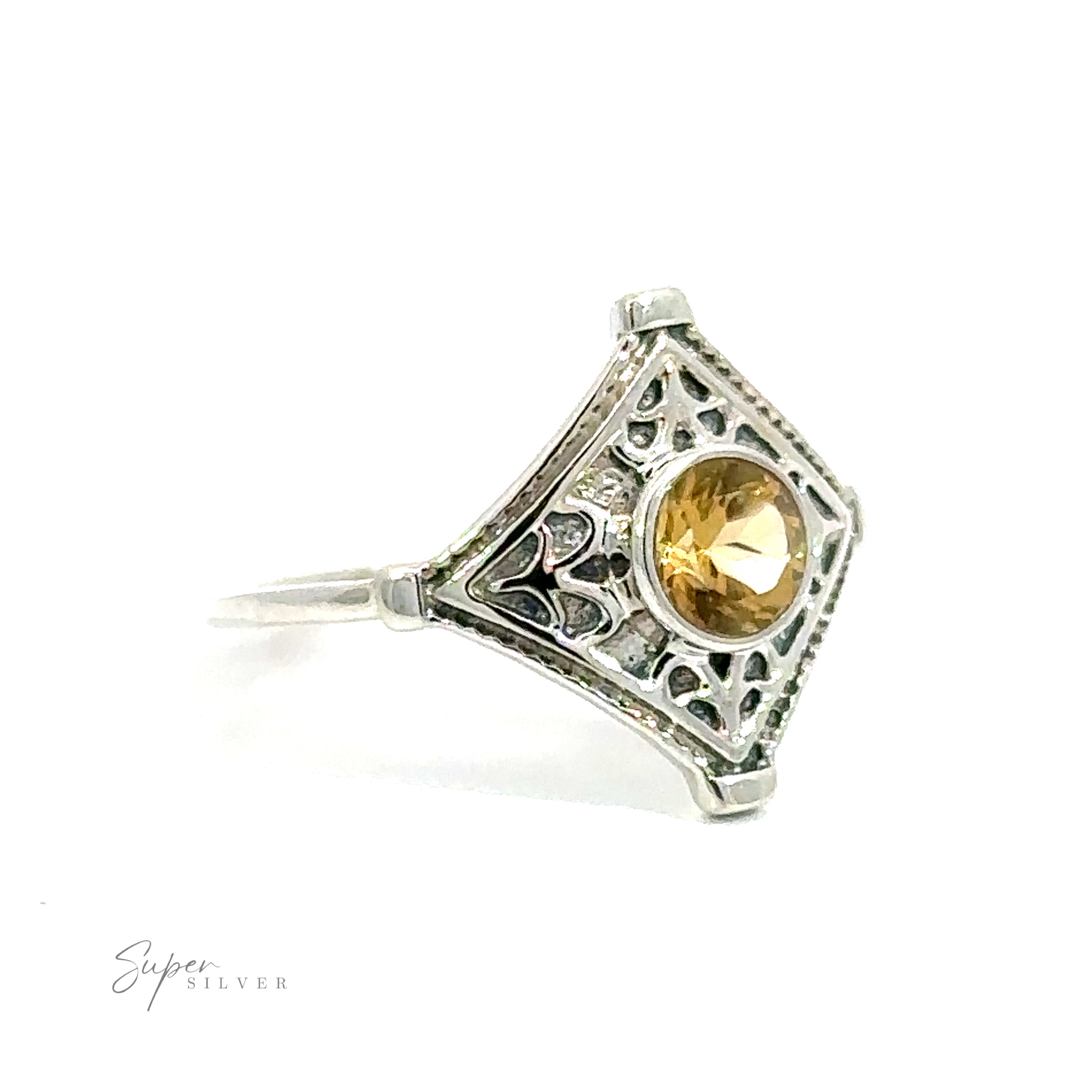 Intricate Diamond Silver ring with a central yellow gemstone set in a triangular, ornate design with detailed engravings, on a white background.