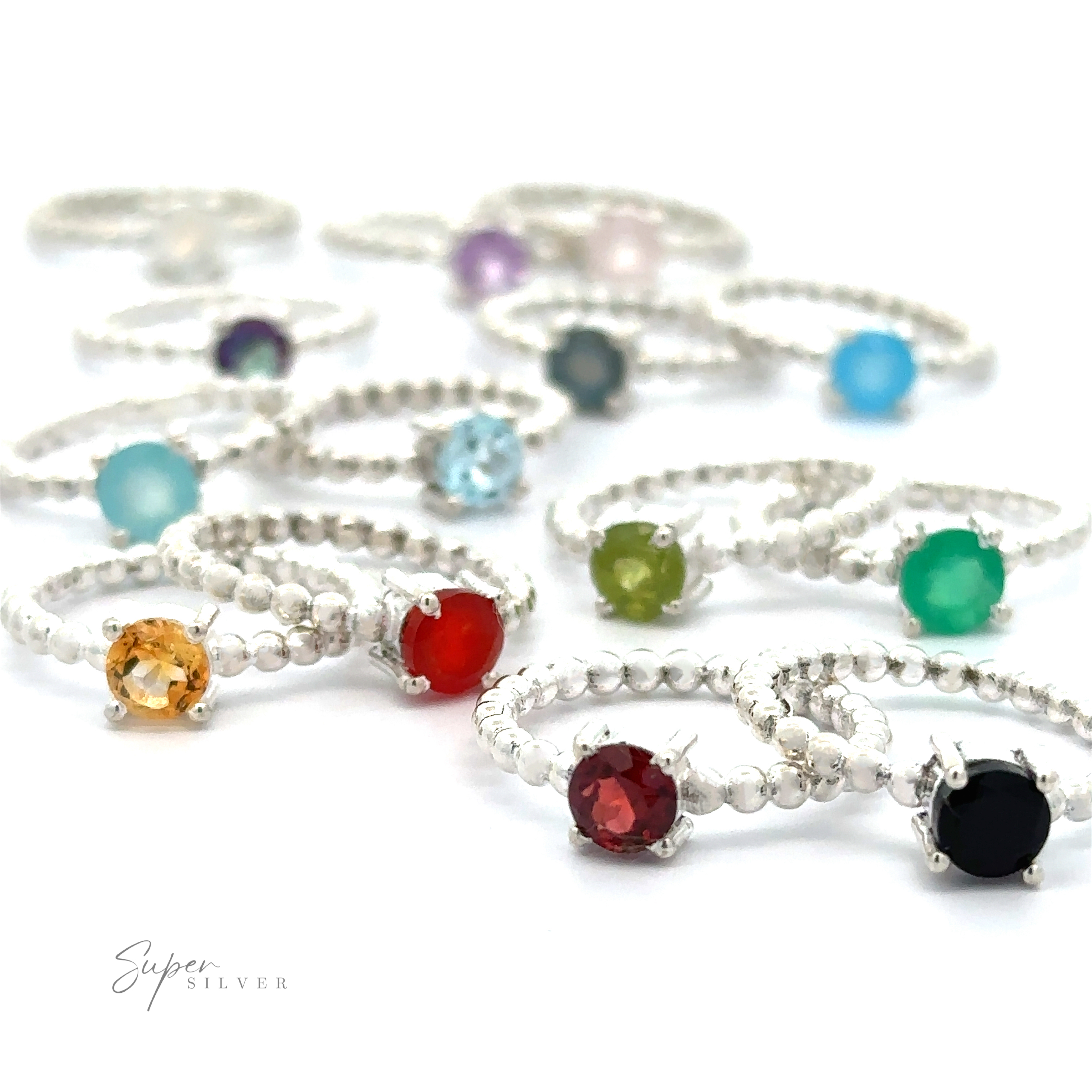 A collection of Stunning Circular Gemstone Rings with Beaded Bands on a white background.