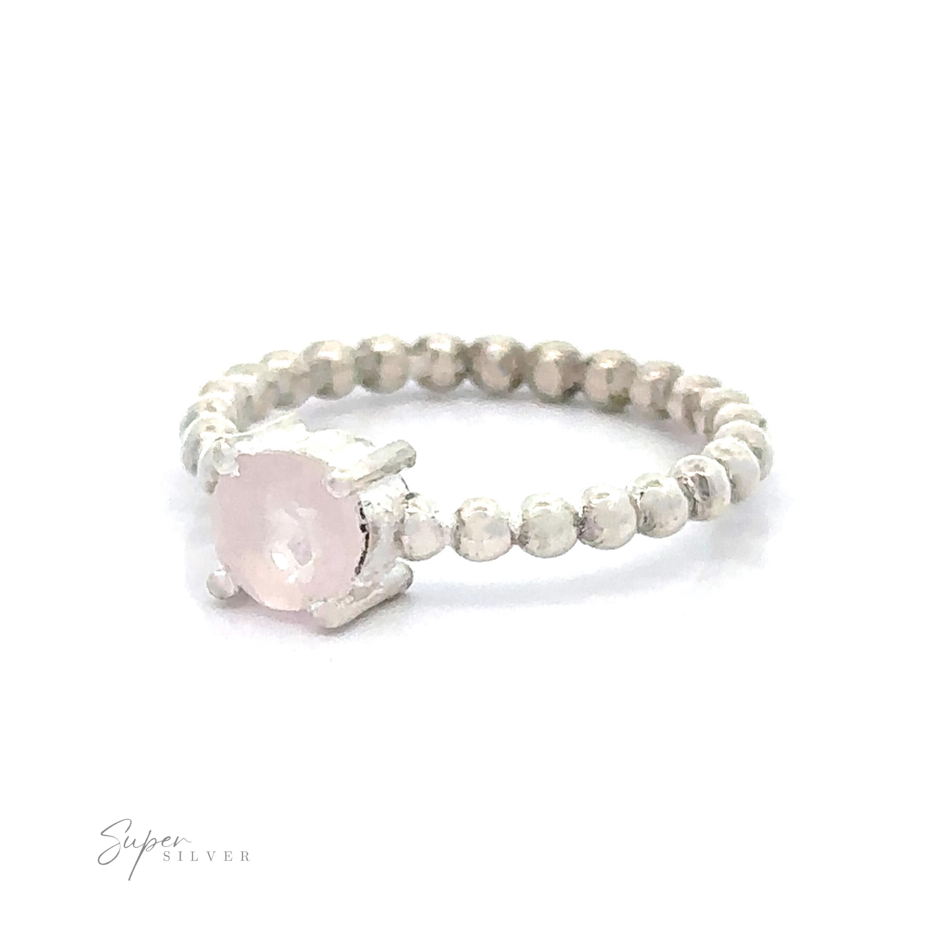 A Stunning Circular Gemstone Ring with a pink gemstone and beaded band design.