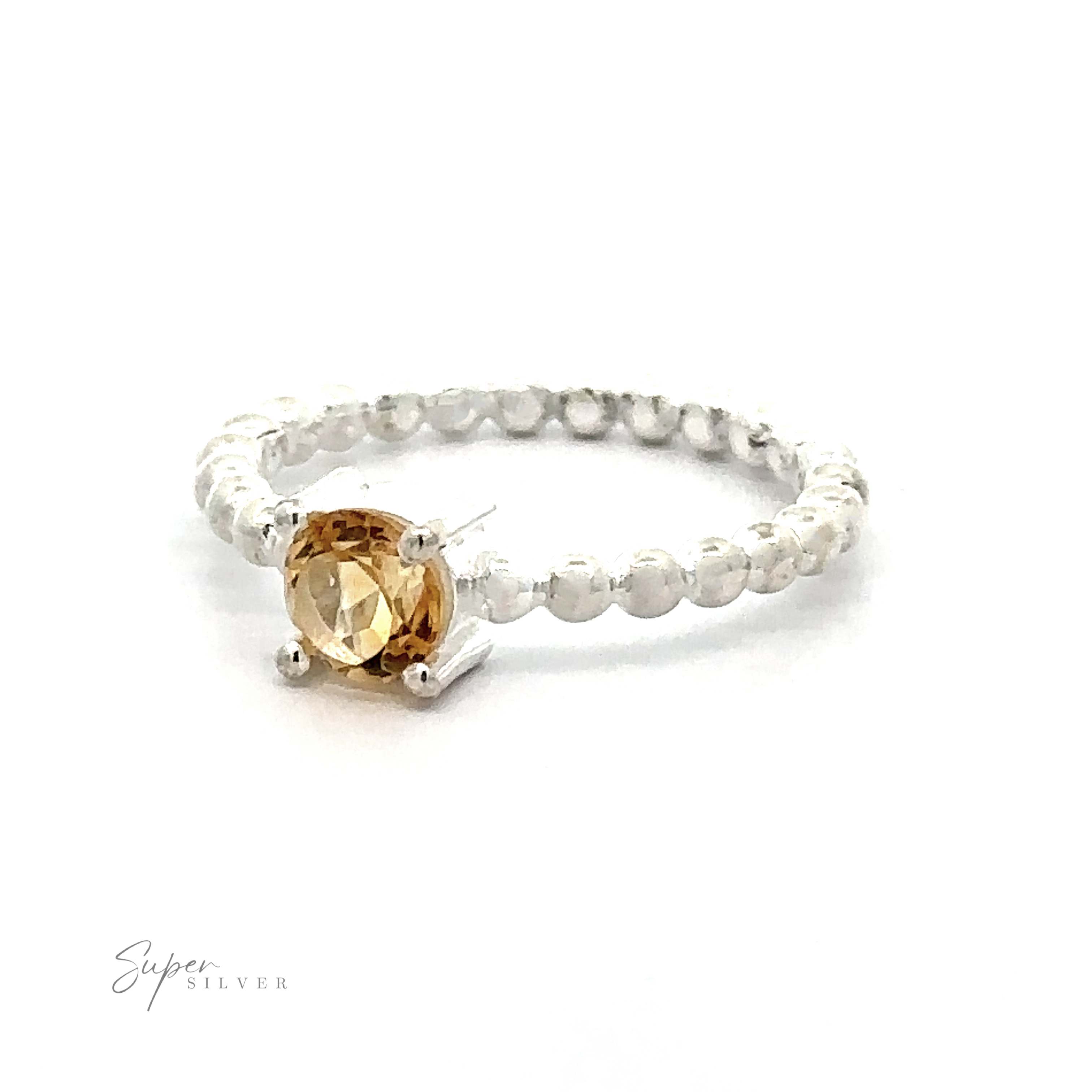 A Stunning Circular Gemstone Ring with Beaded Band with a central amber-colored gemstone on a white background.