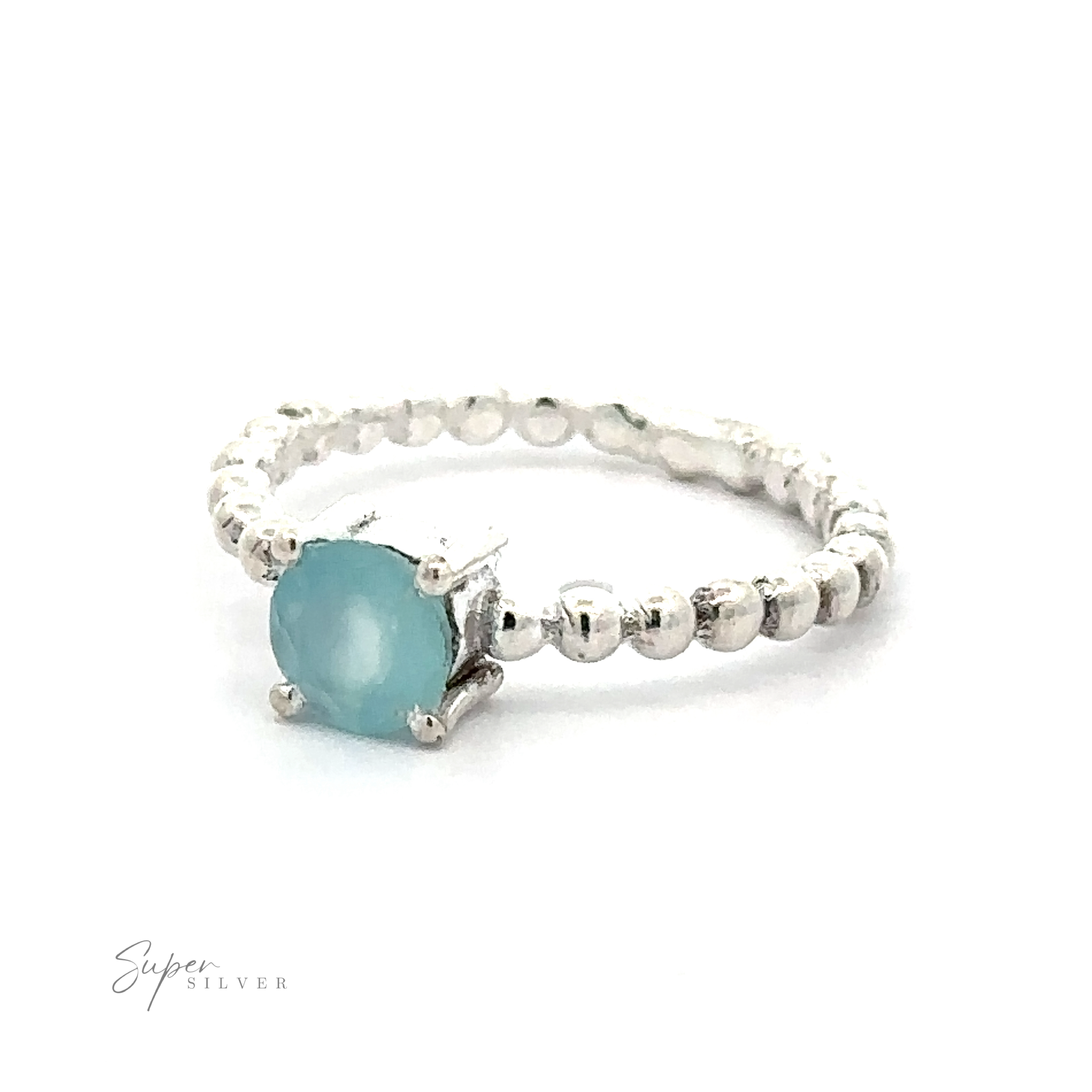 Stunning Circular Gemstone Ring with Beaded Band with a vibrant blue gemstone and dotted detailing on a white background.