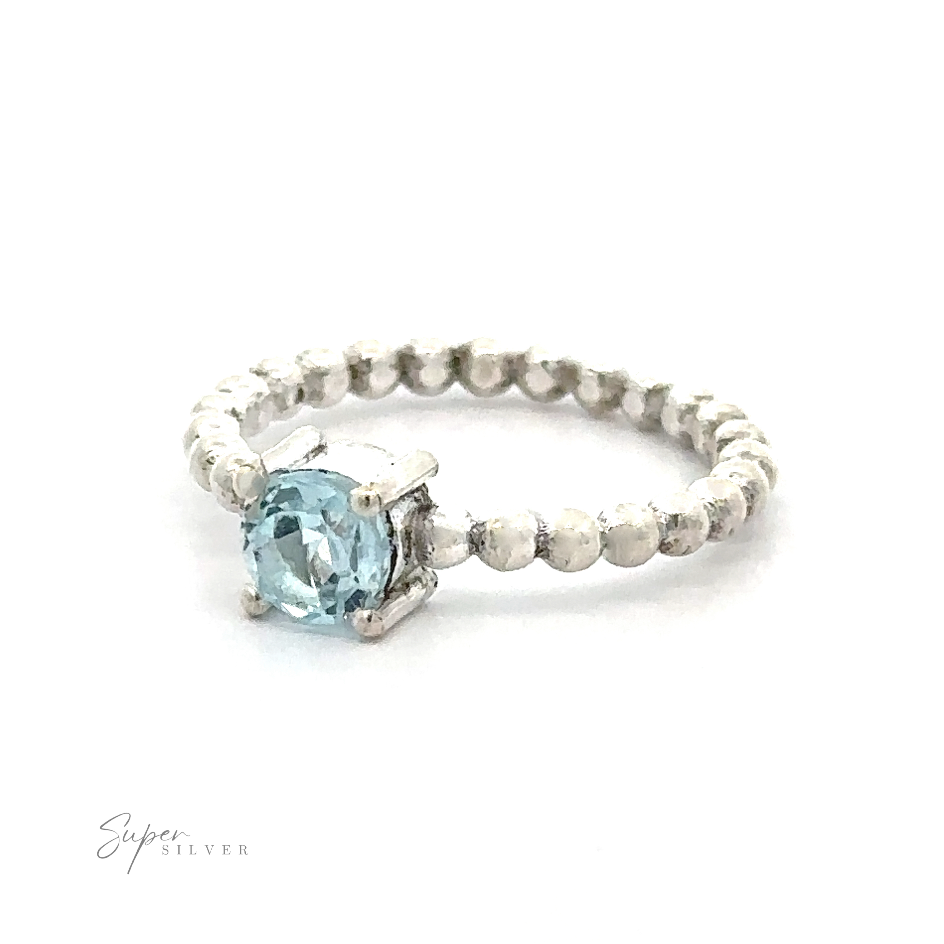 A stunning circular gemstone ring with a single vibrant blue gemstone set in a prong setting on a textured band.