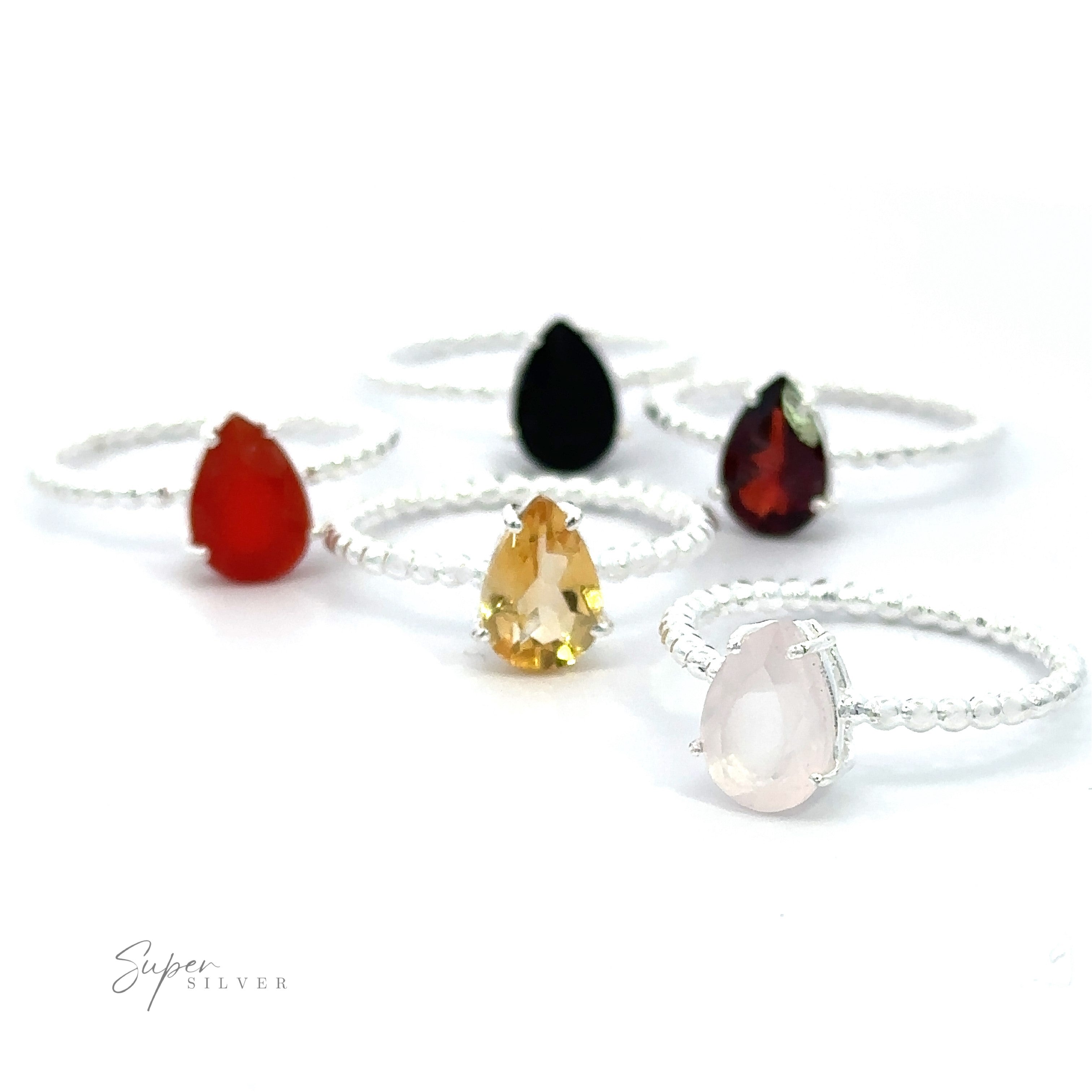 An assortment of Vibrant Teardrop Gemstone Rings with Beaded Bands on a white background.