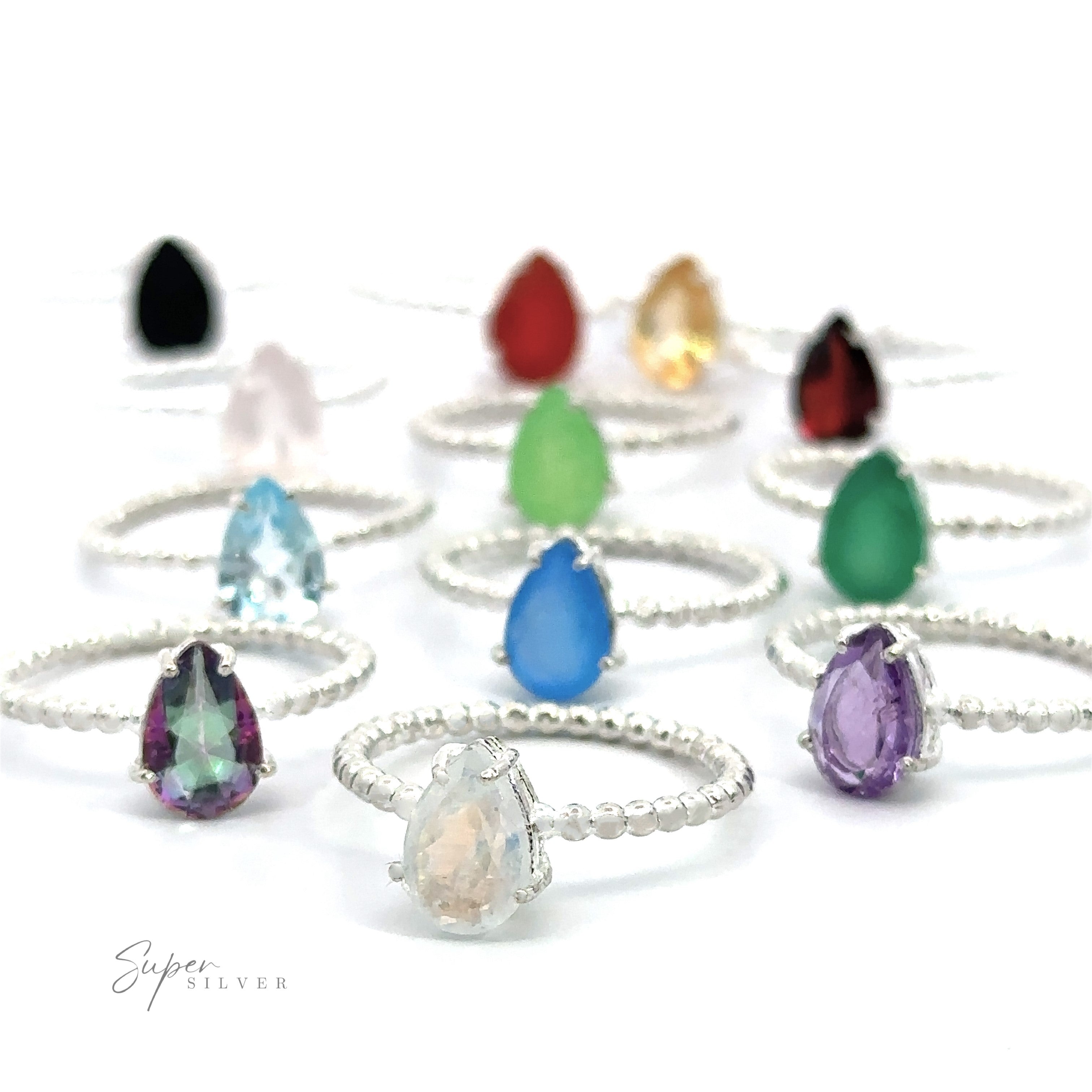 A collection of Vibrant Teardrop Gemstone Rings with Beaded Bands displayed against a white background.