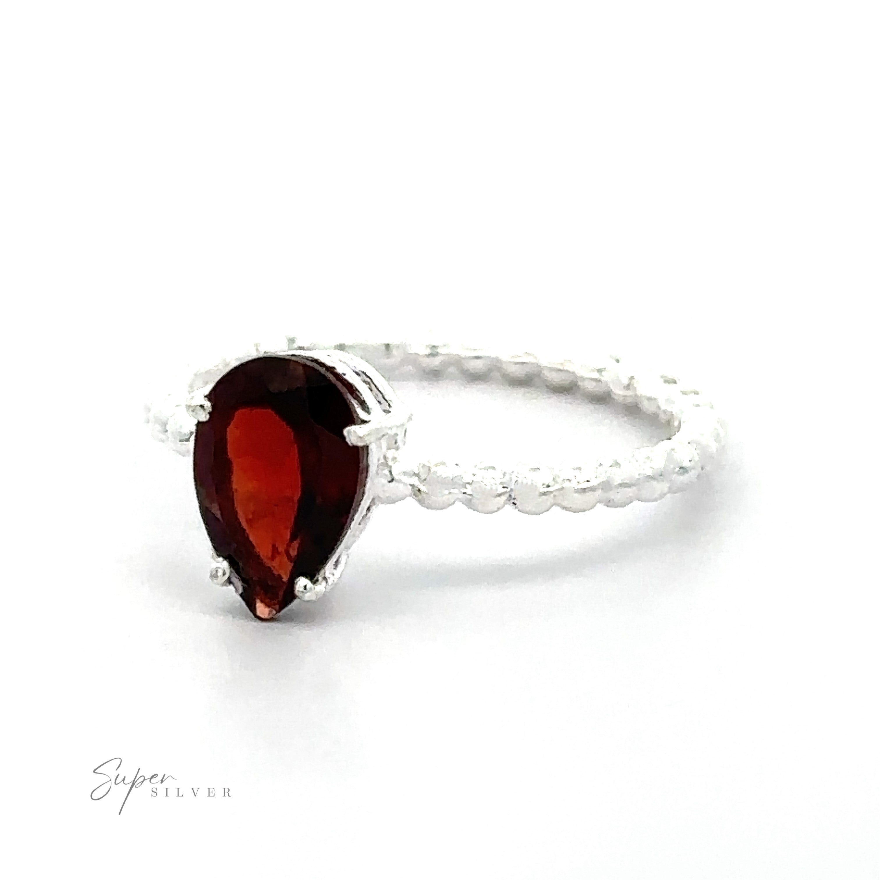 A Vibrant Teardrop Gemstone Ring with Beaded Band with a marquise-cut garnet set in a simple mount on a white background.